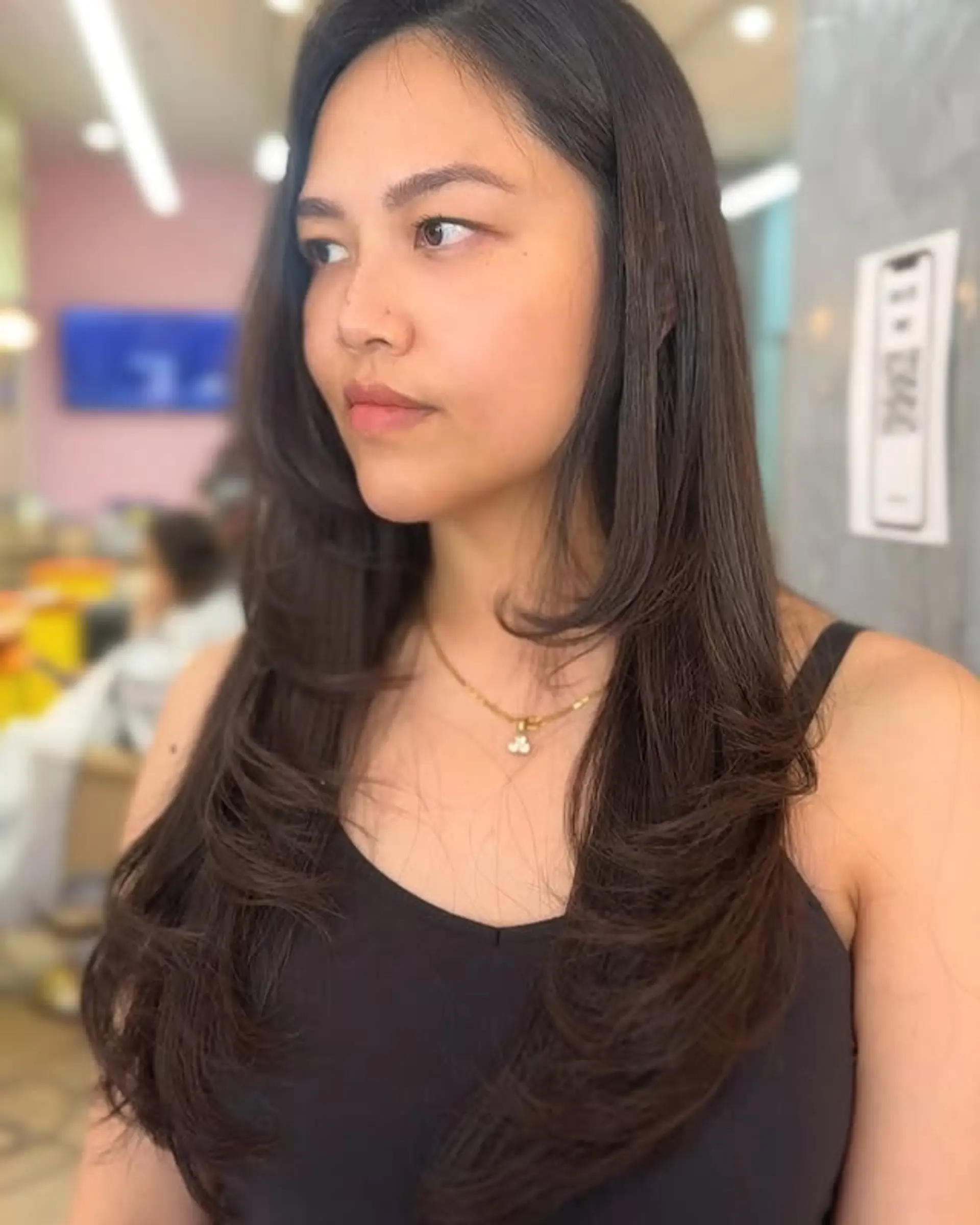 A long, layered hairstyle with face-framing butterfly layers. 1