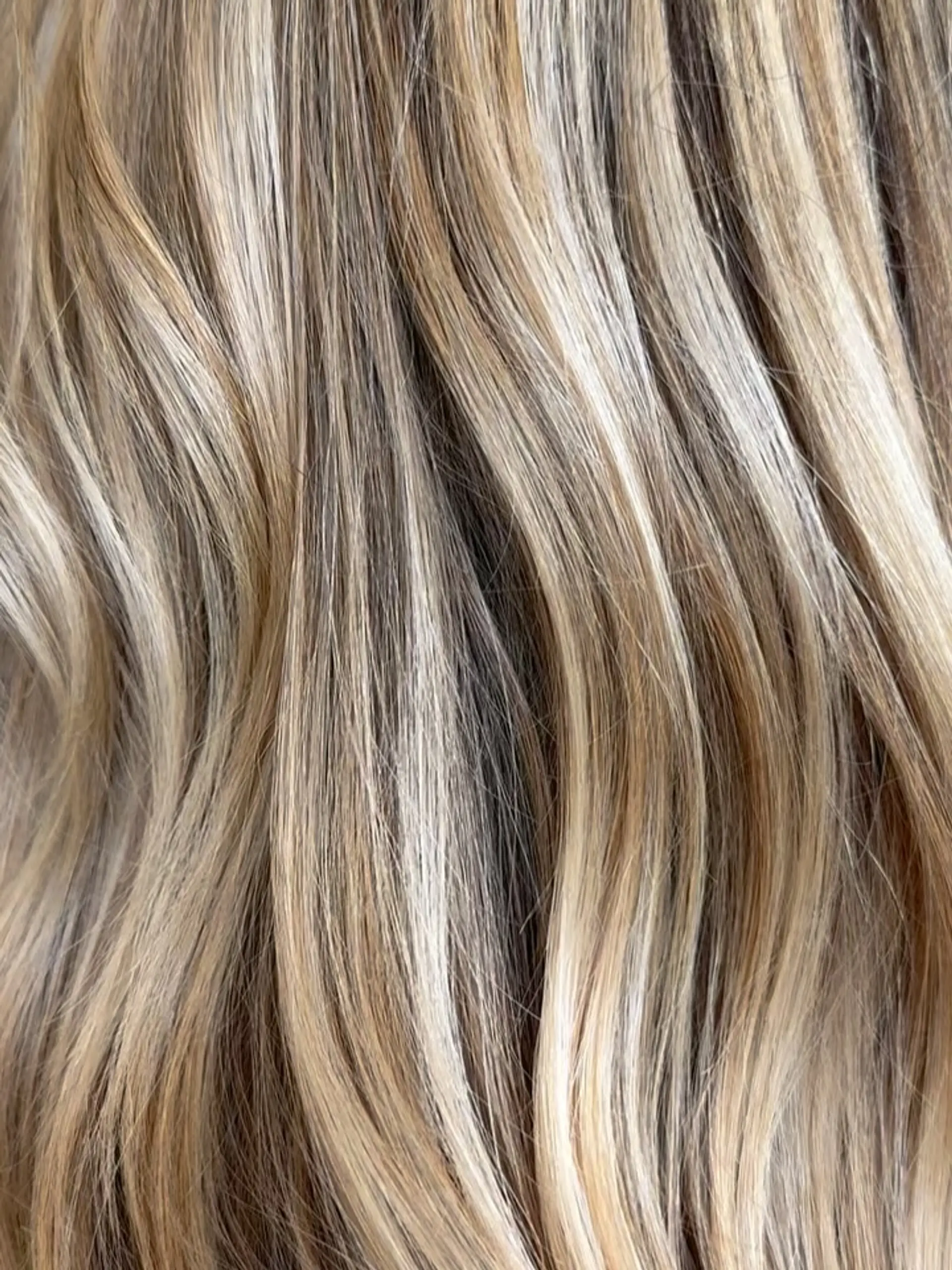 Multi-tonal blonde highlights blended seamlessly with a natural base. 1