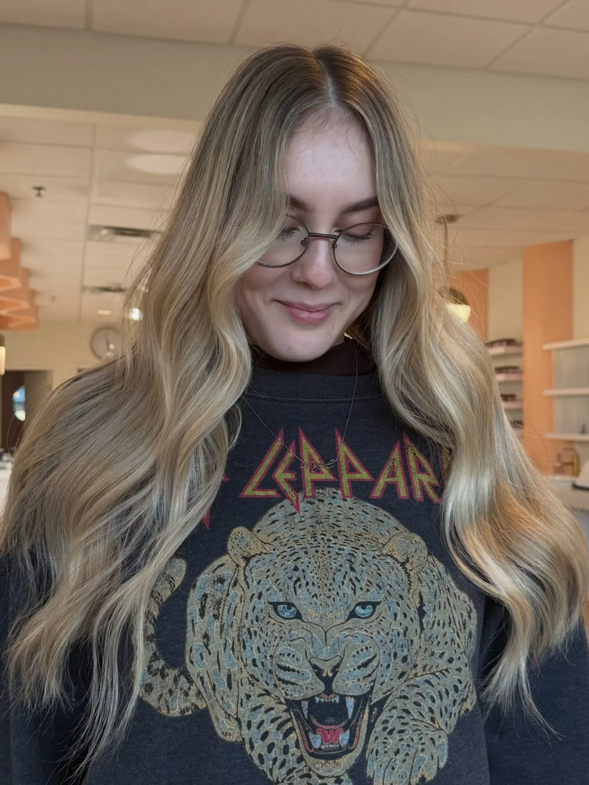 Long, bright blonde hair with a soft shadow root styled in relaxed, loose waves. 1