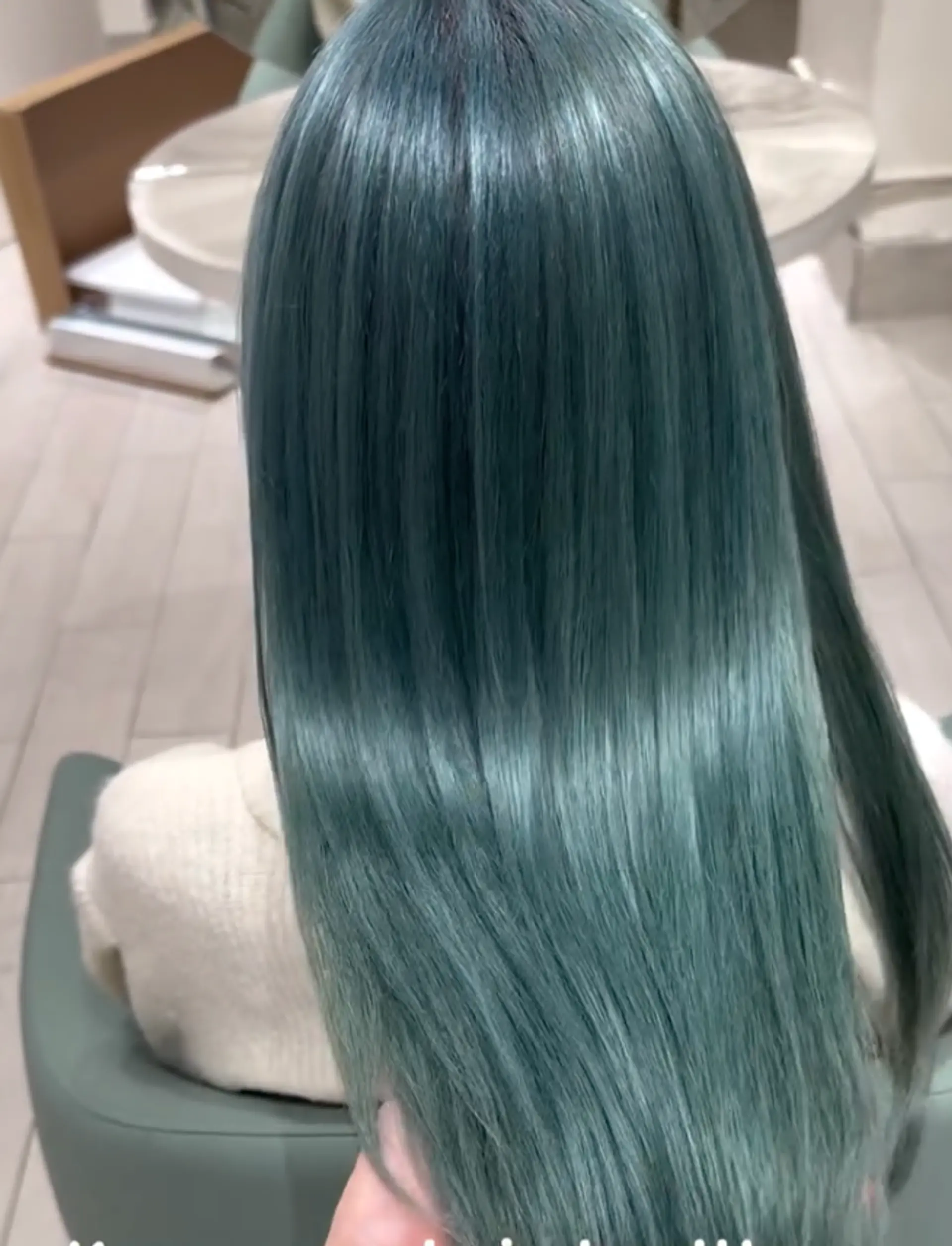 A long, straight, and sleek hairstyle with a vibrant teal color, creating a smooth and polished look that cascades down the back. 1