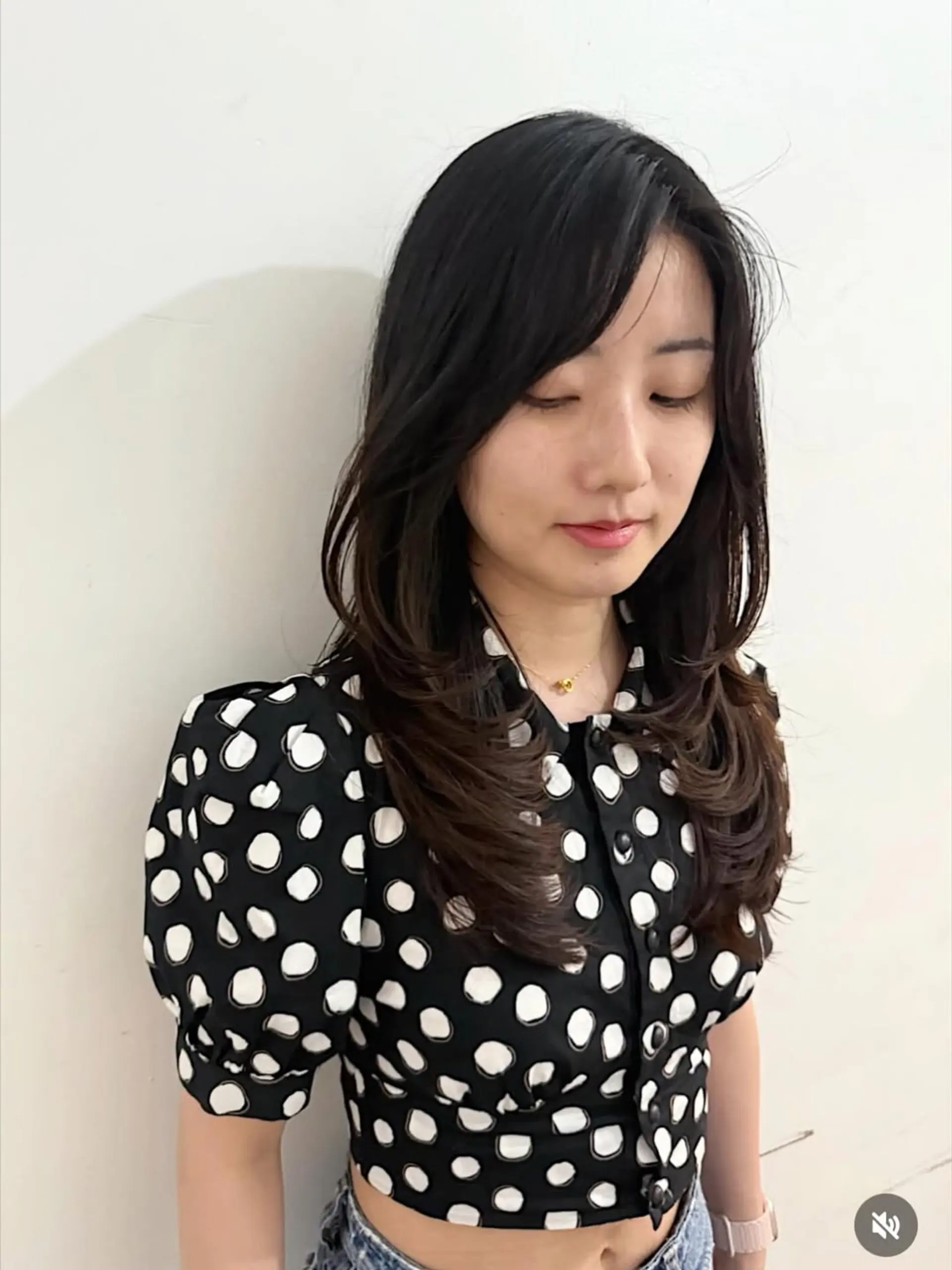 A sophisticated medium-length haircut featuring long, cascading layers that add movement and body, complemented by soft, face-framing curtain bangs. The style is finished with gentle waves at the ends. 1