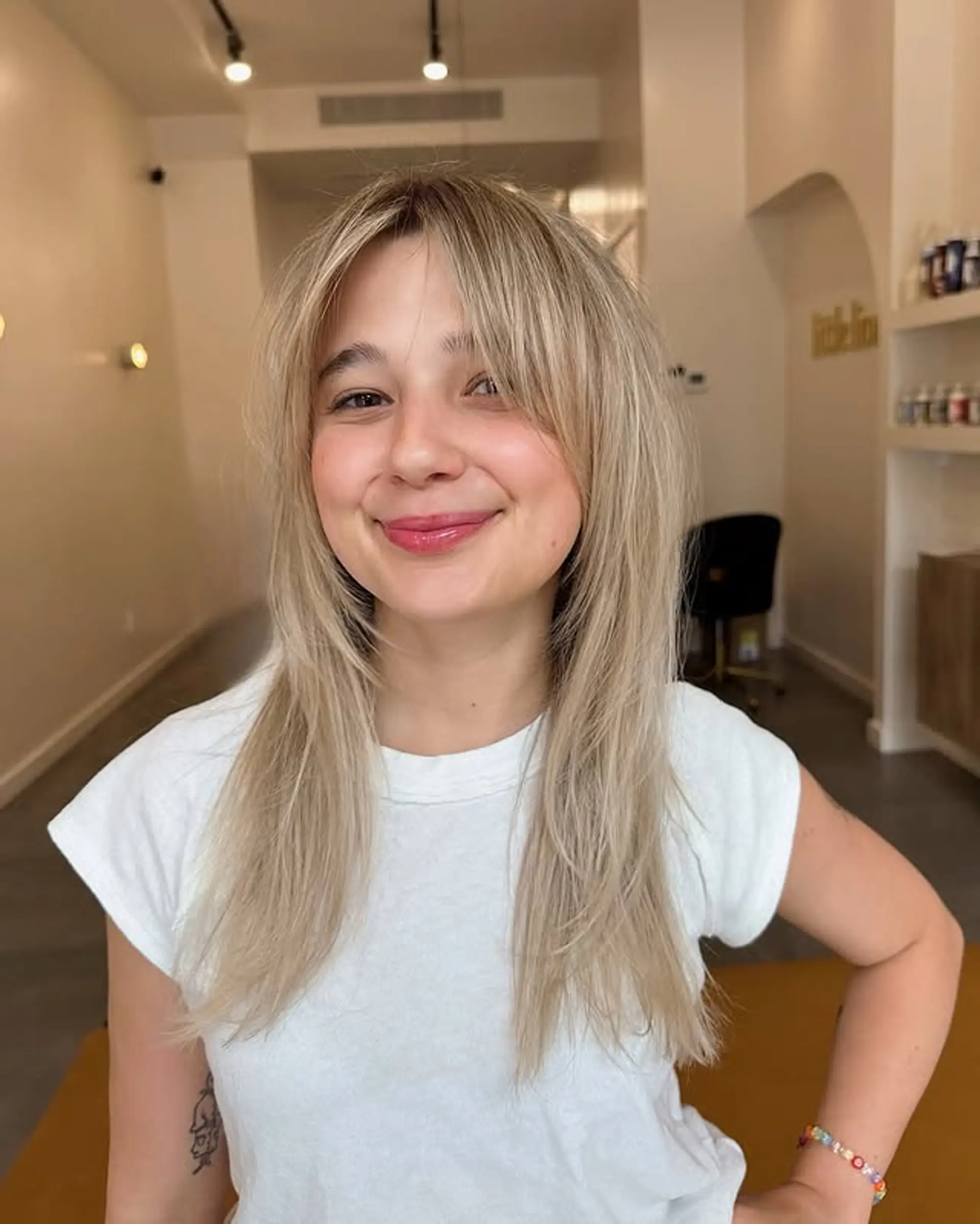 A modern shag haircut with face-framing layers and Bardot-style bangs. 1