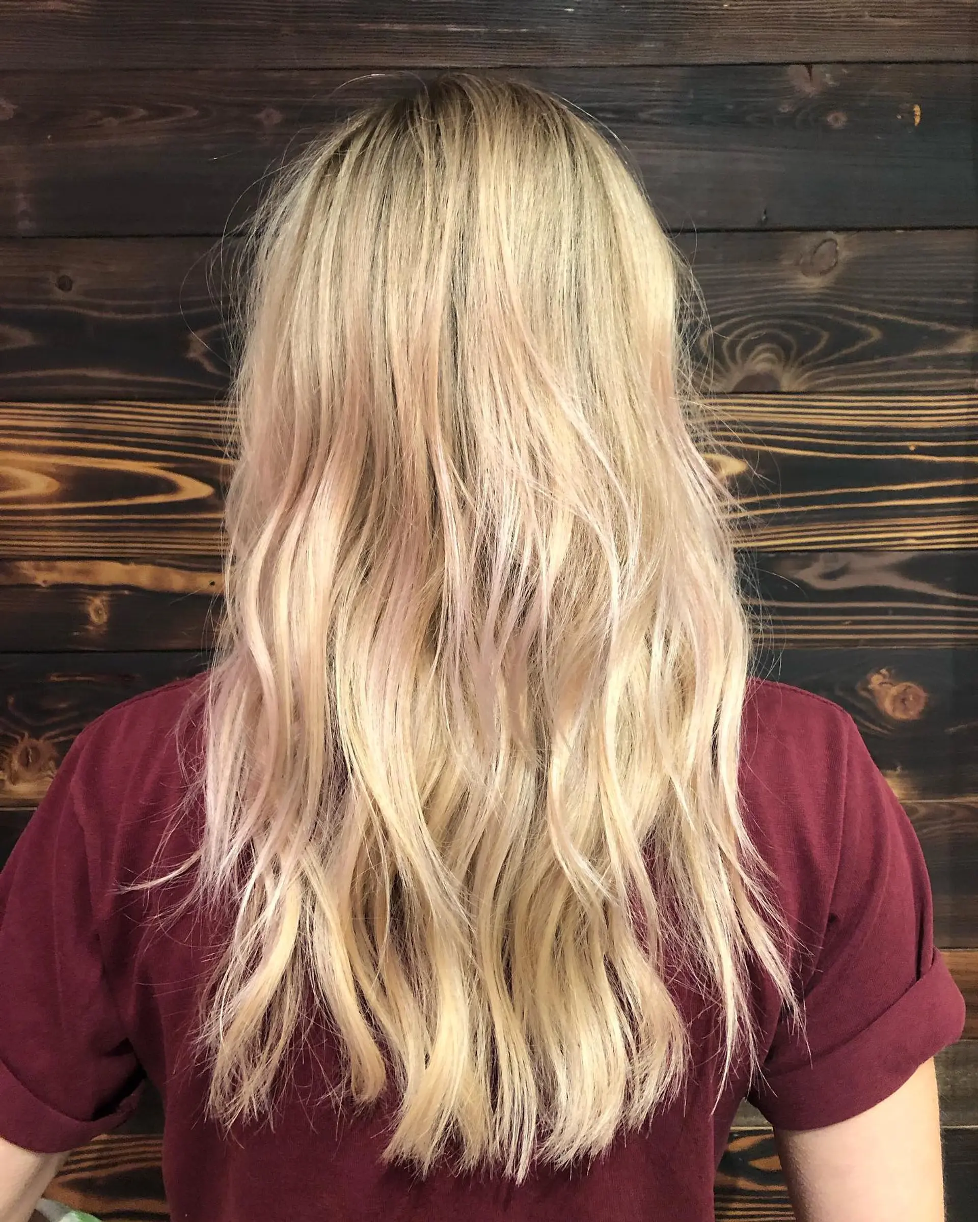 Long, layered blonde waves with rose gold highlights. 1