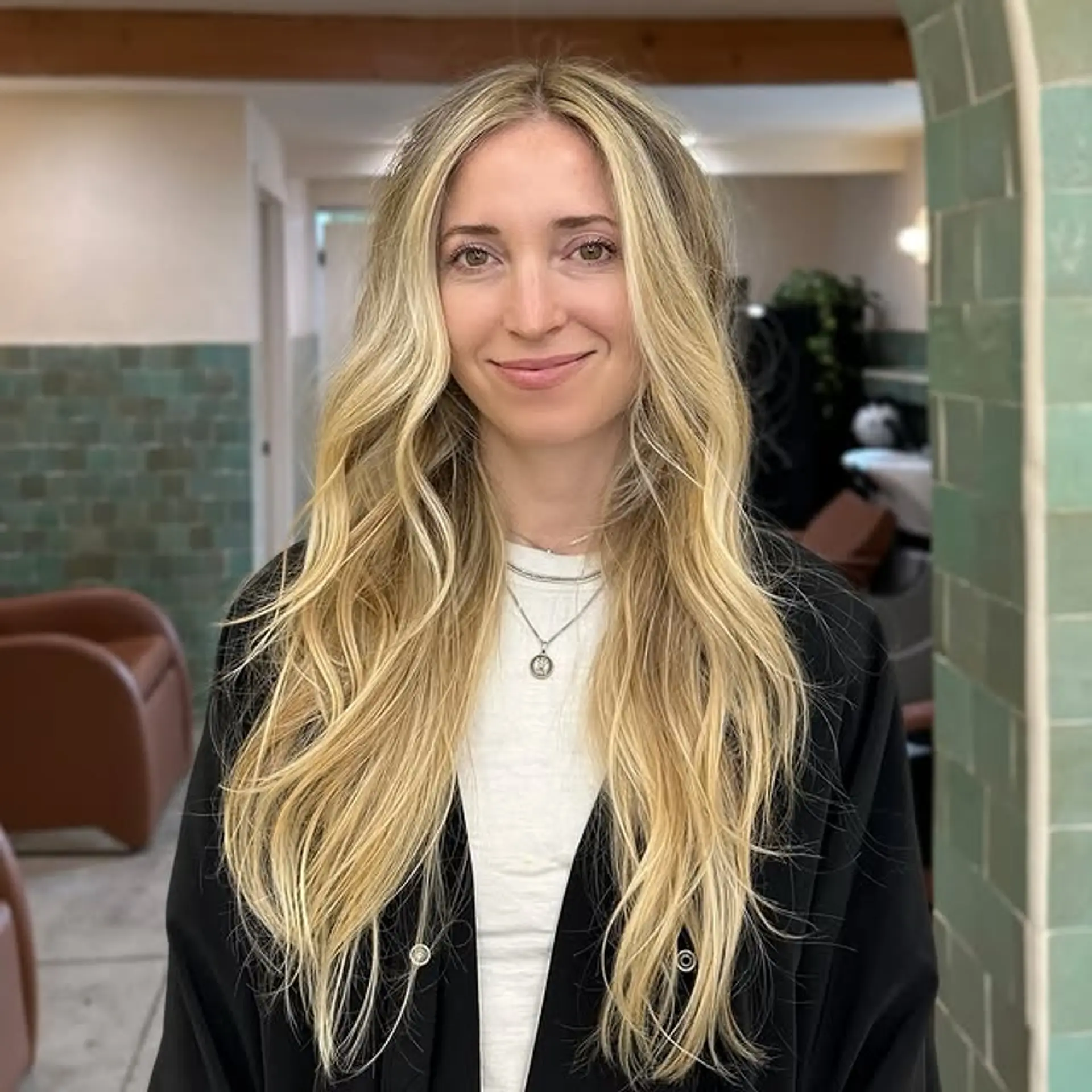 Long, wavy blonde balayage with beachy waves and face-framing highlights. 1