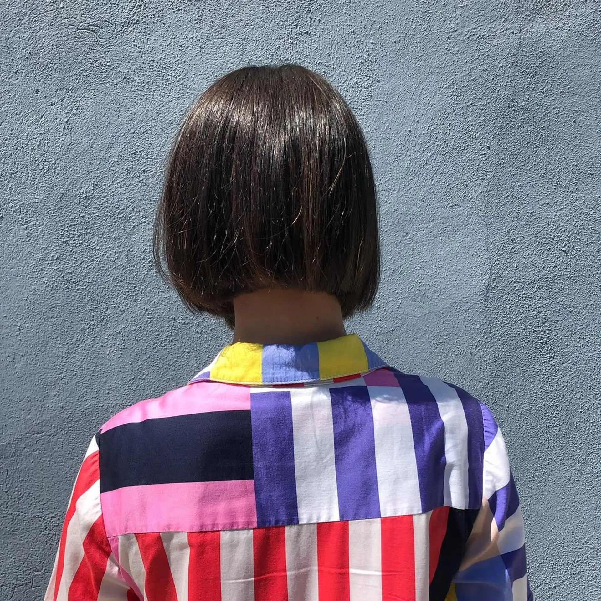 A sleek, straight, blunt cut bob with a glossy finish, characterized by short length and a precision line. 2