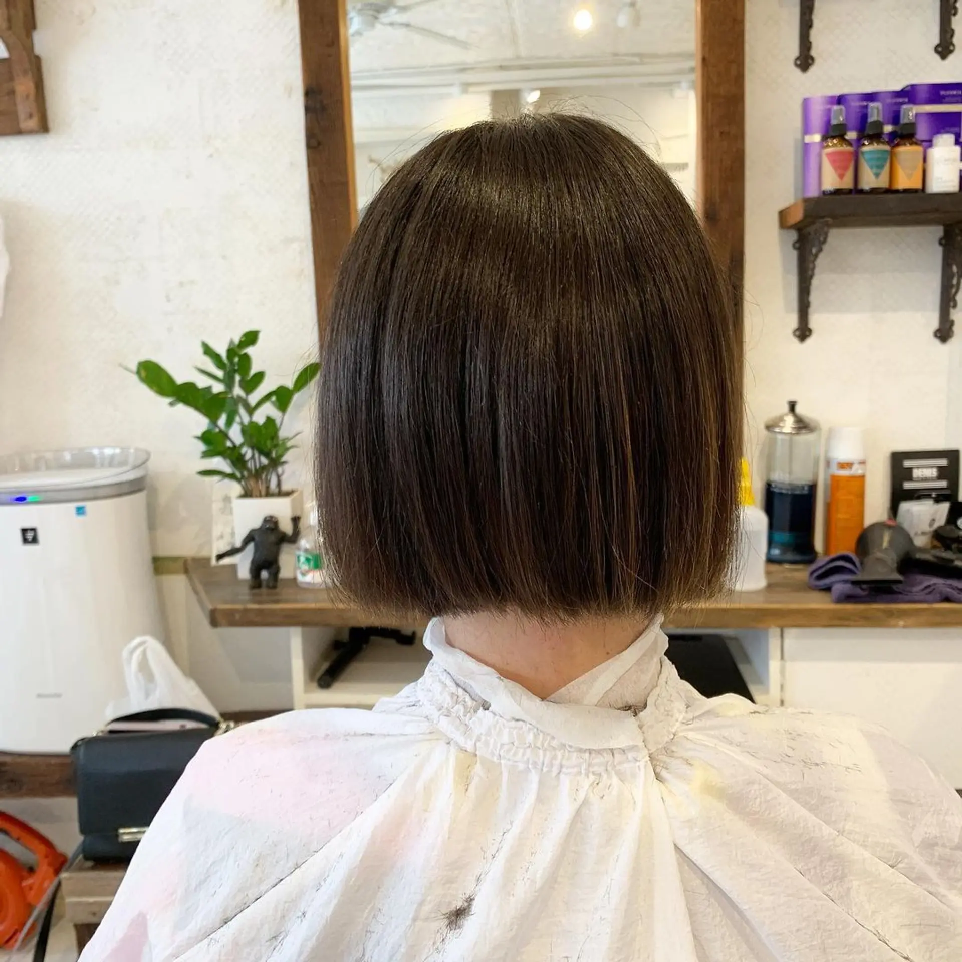 A sleek, straight, blunt cut bob with a glossy finish, characterized by short length and a precision line. 3