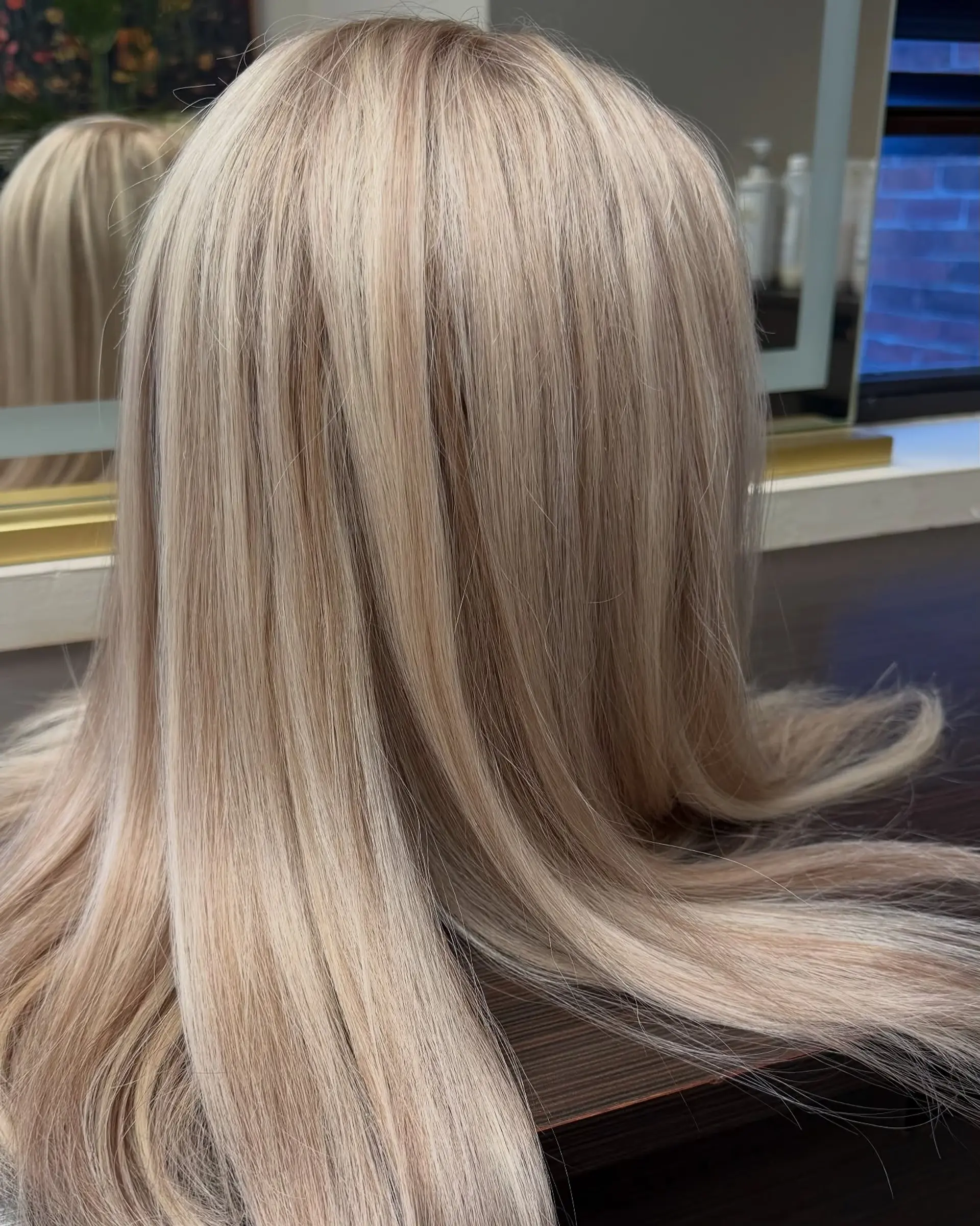 Straight, sleek long hair styled with fine, multi-dimensional blonde highlights and soft lowlights. 1