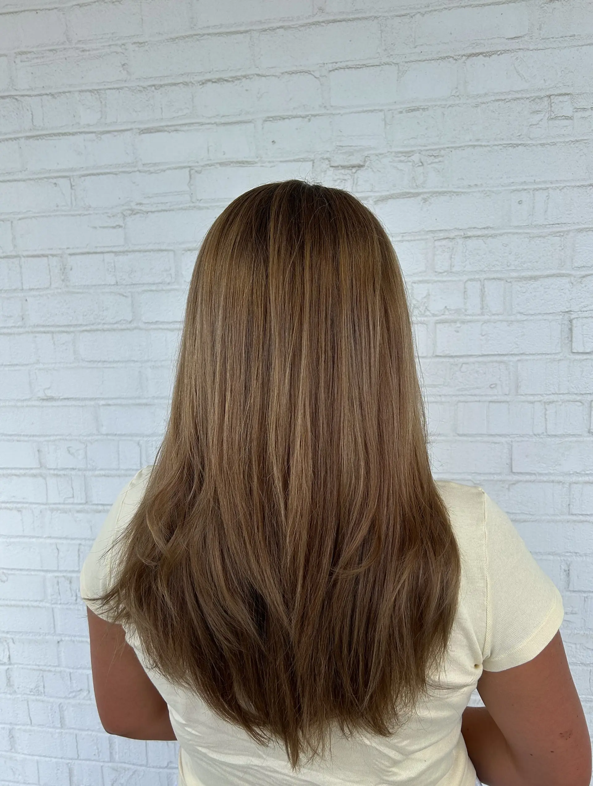Long, smooth light brown hair featuring subtle soft layers and gently tapered ends. 1
