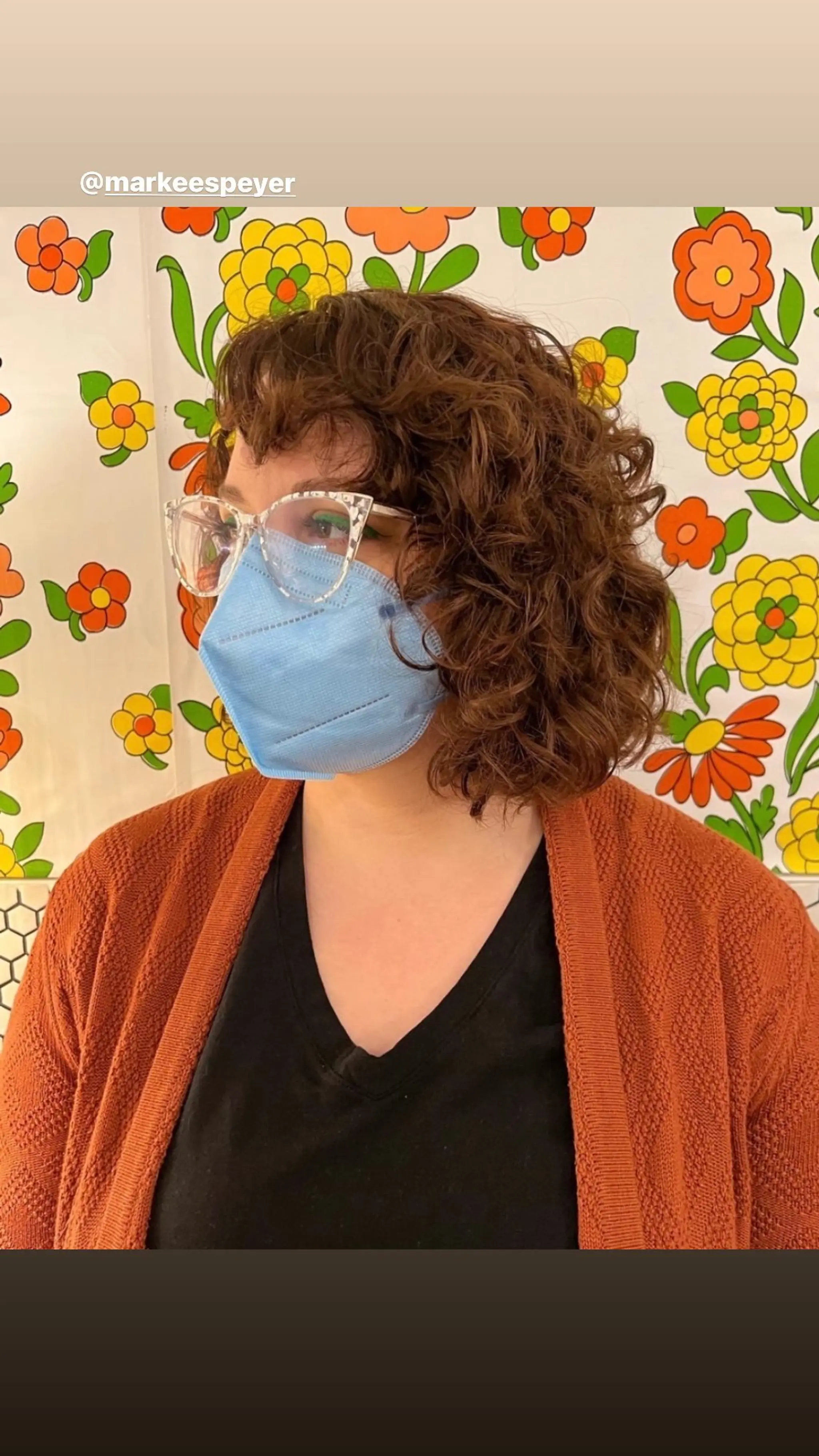 A stylish, voluminous curly bob with natural bangs.