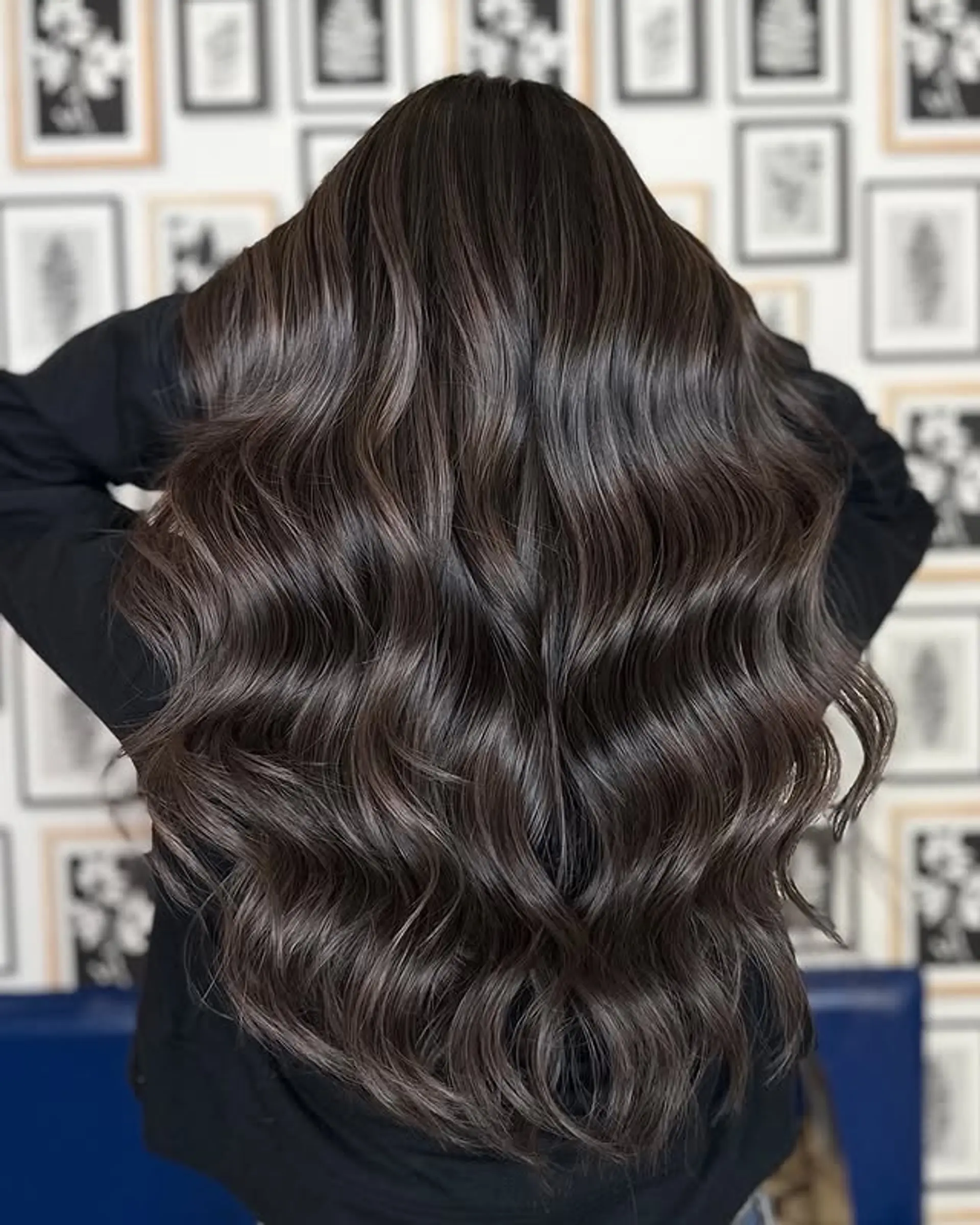 Long, dark brown hair with soft waves and subtle layers. 1