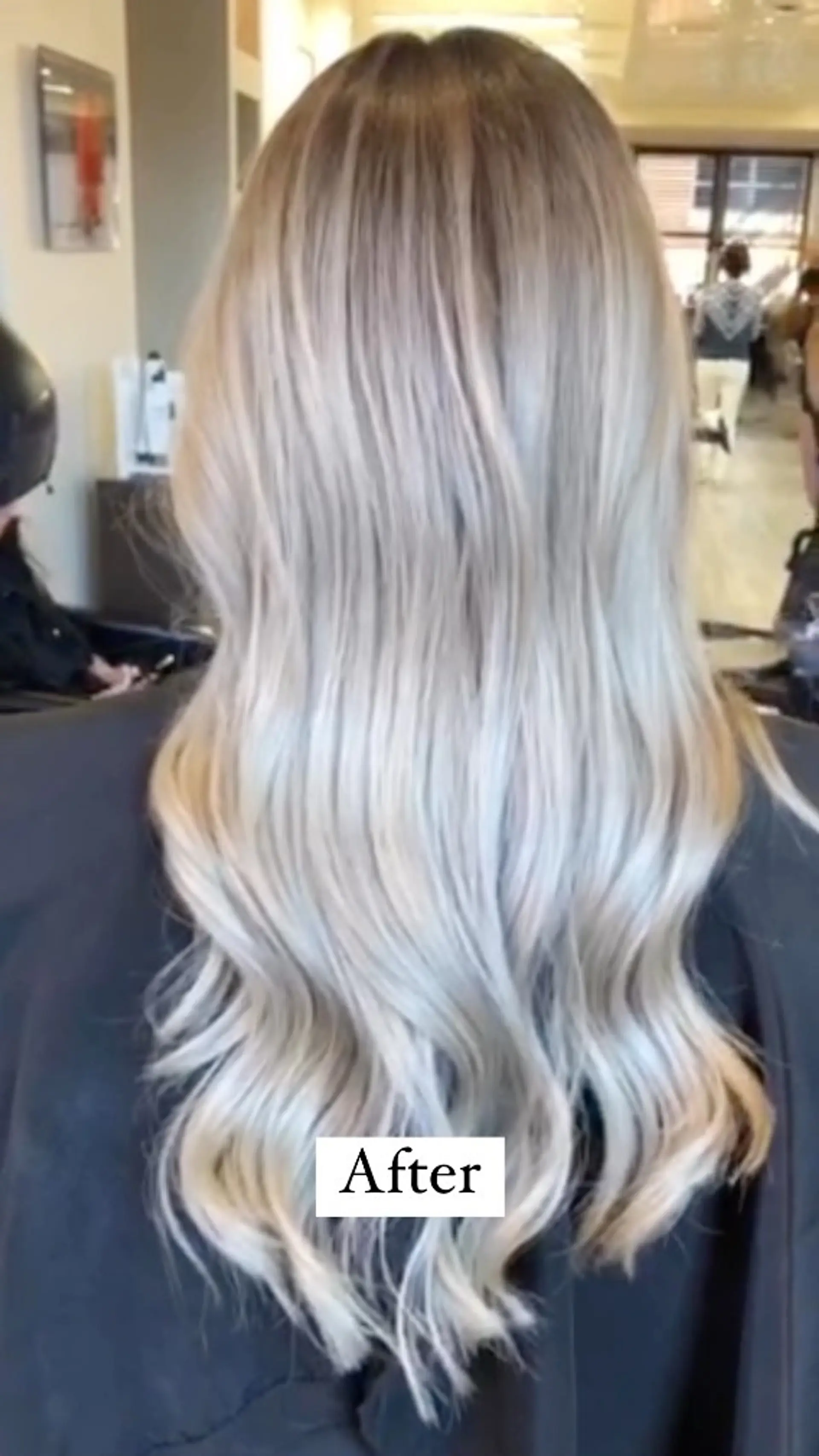 Long icy platinum blonde hair styled with soft, cascading loose waves and a seamless root melt. 1