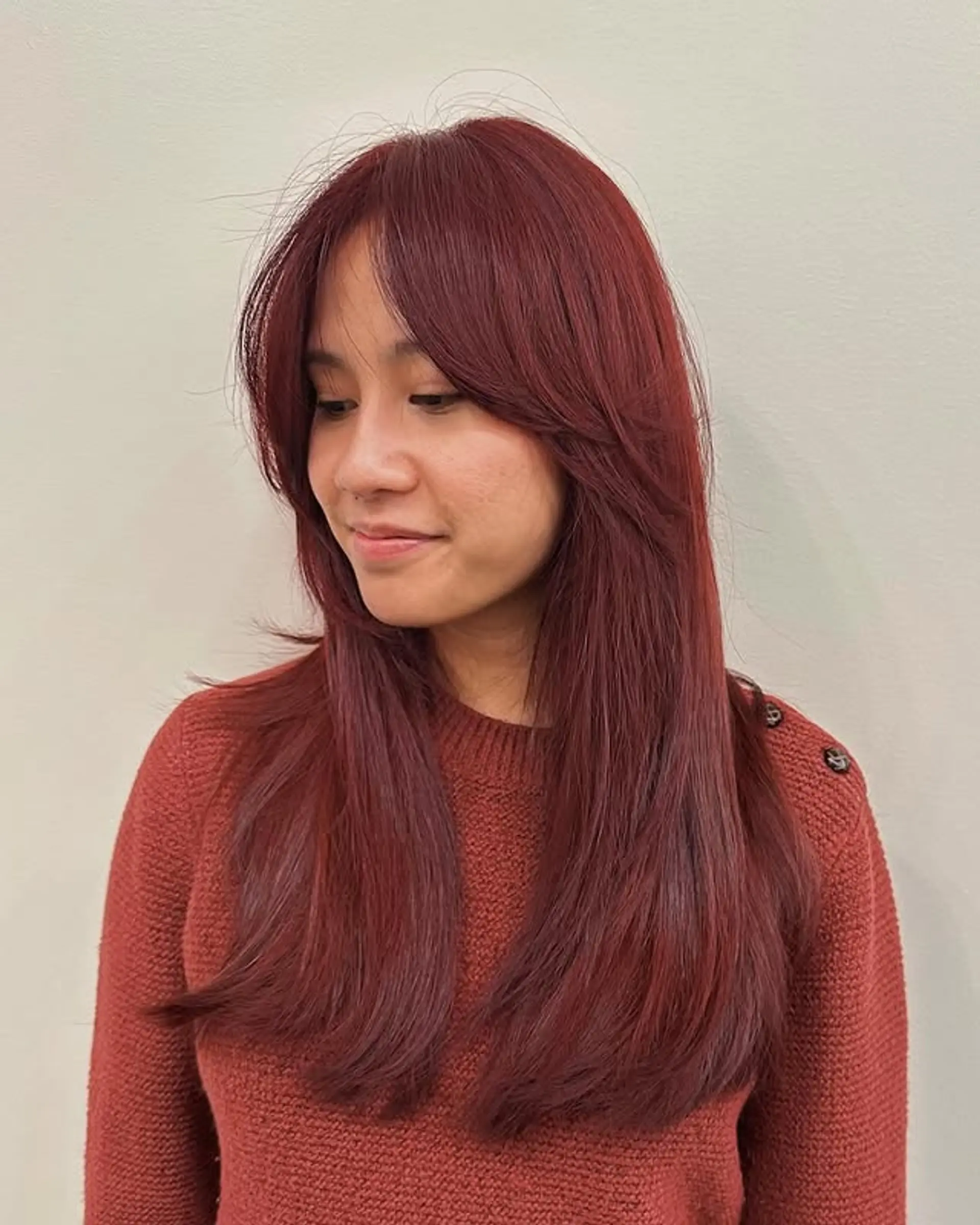 Long layered hairstyle with face-framing layers and curtain bangs. 1