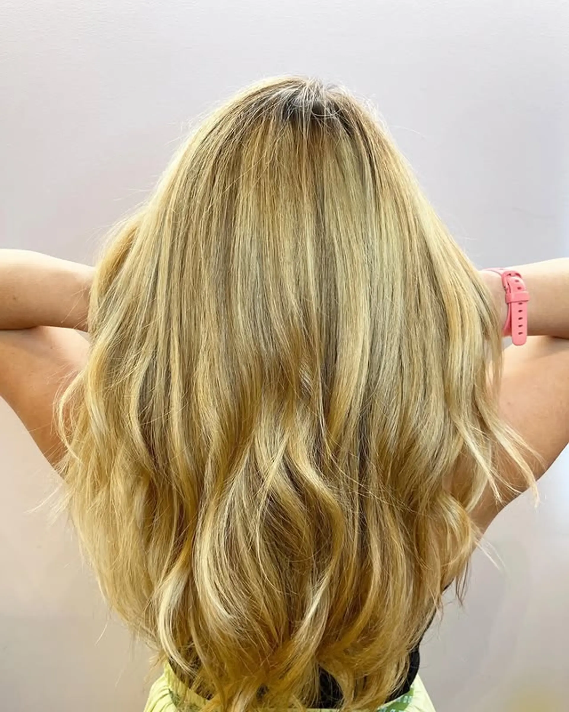 Long wavy hair with subtle layers and blonde balayage. 1