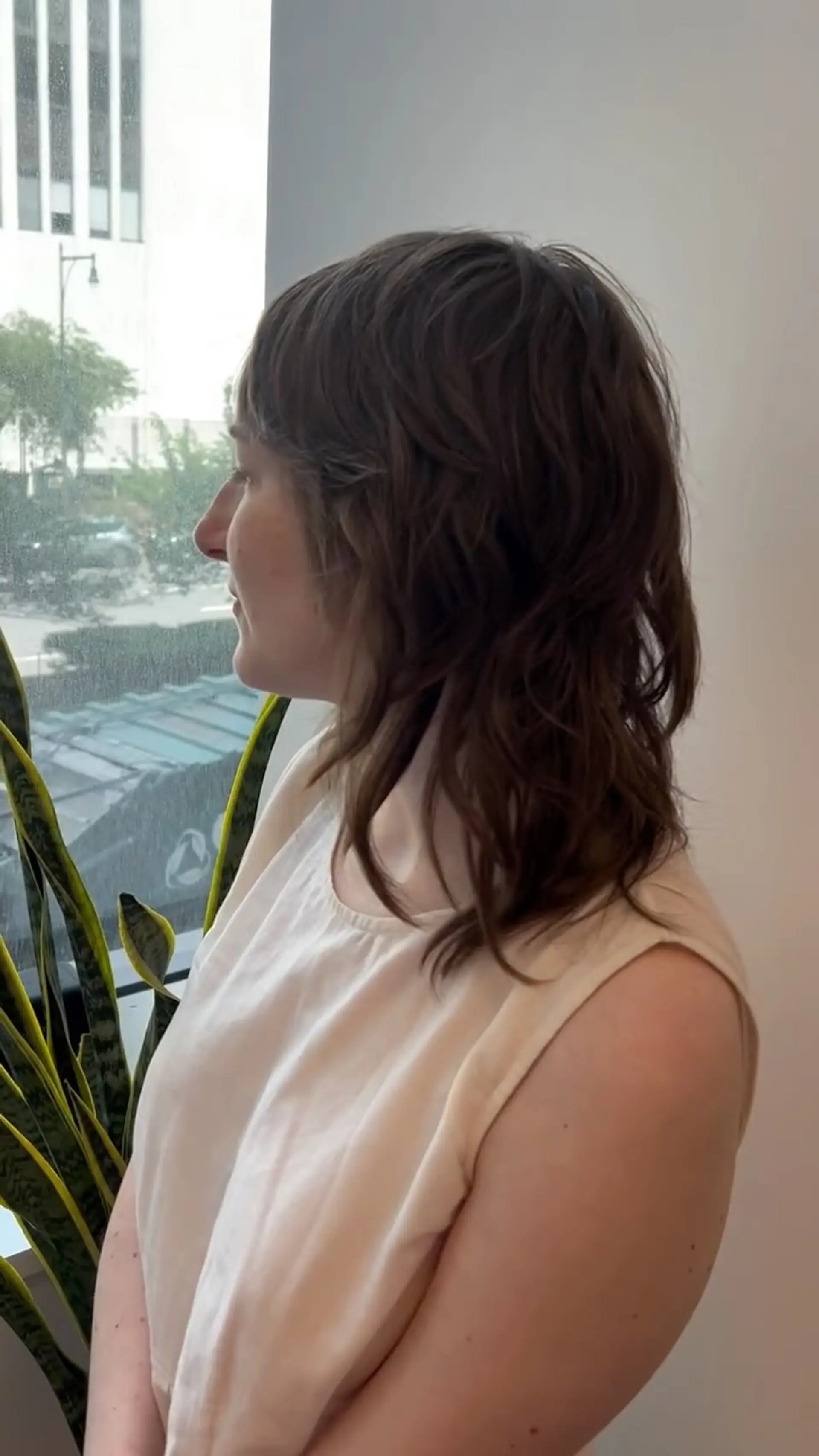 A medium-length textured shag haircut featuring soft waves, feathered layers, and full fringe. 1