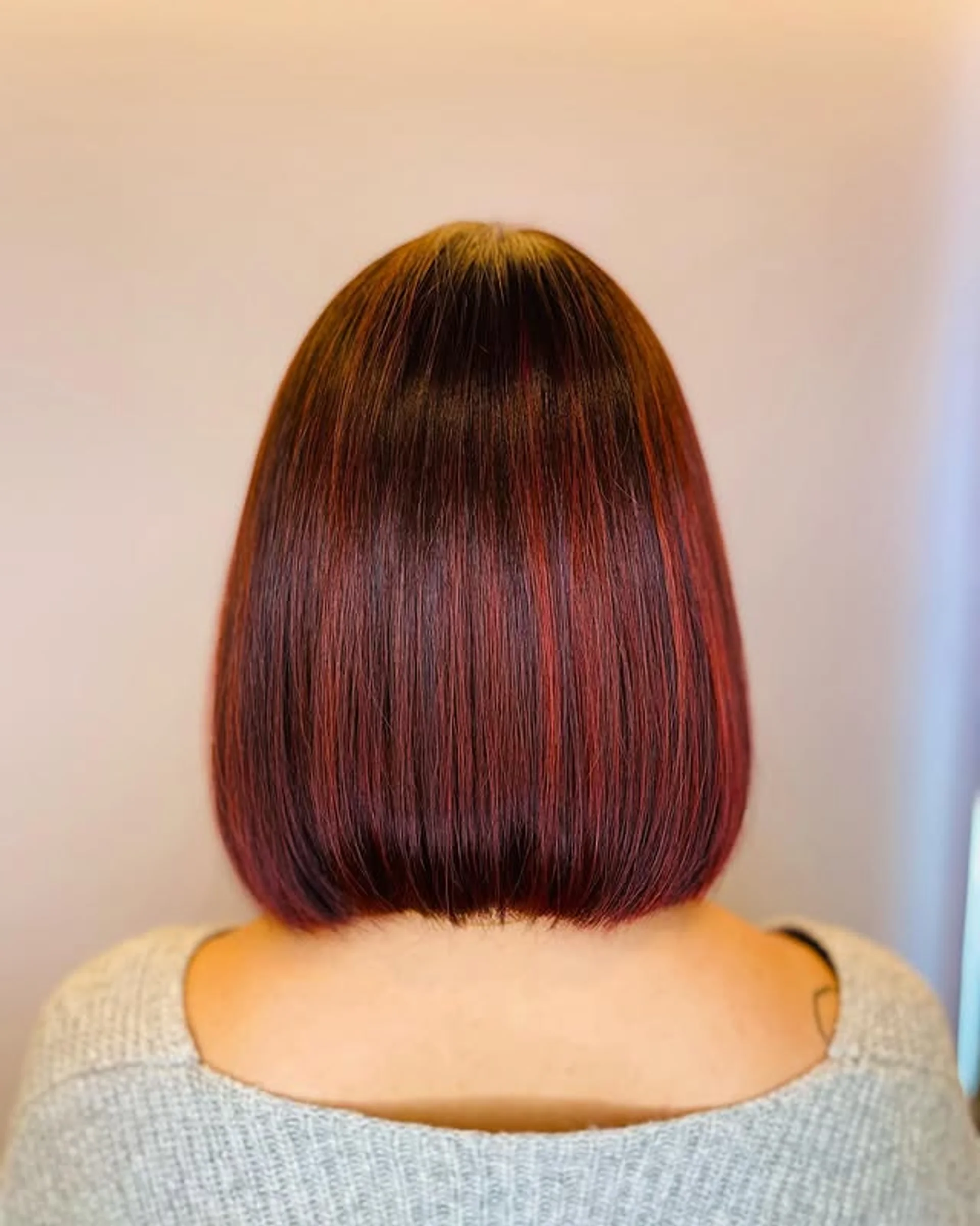 A woman with very long, wavy hair in a rich, deep cherry red color with a glossy, luxurious finish, seen from behind. - Preview 2