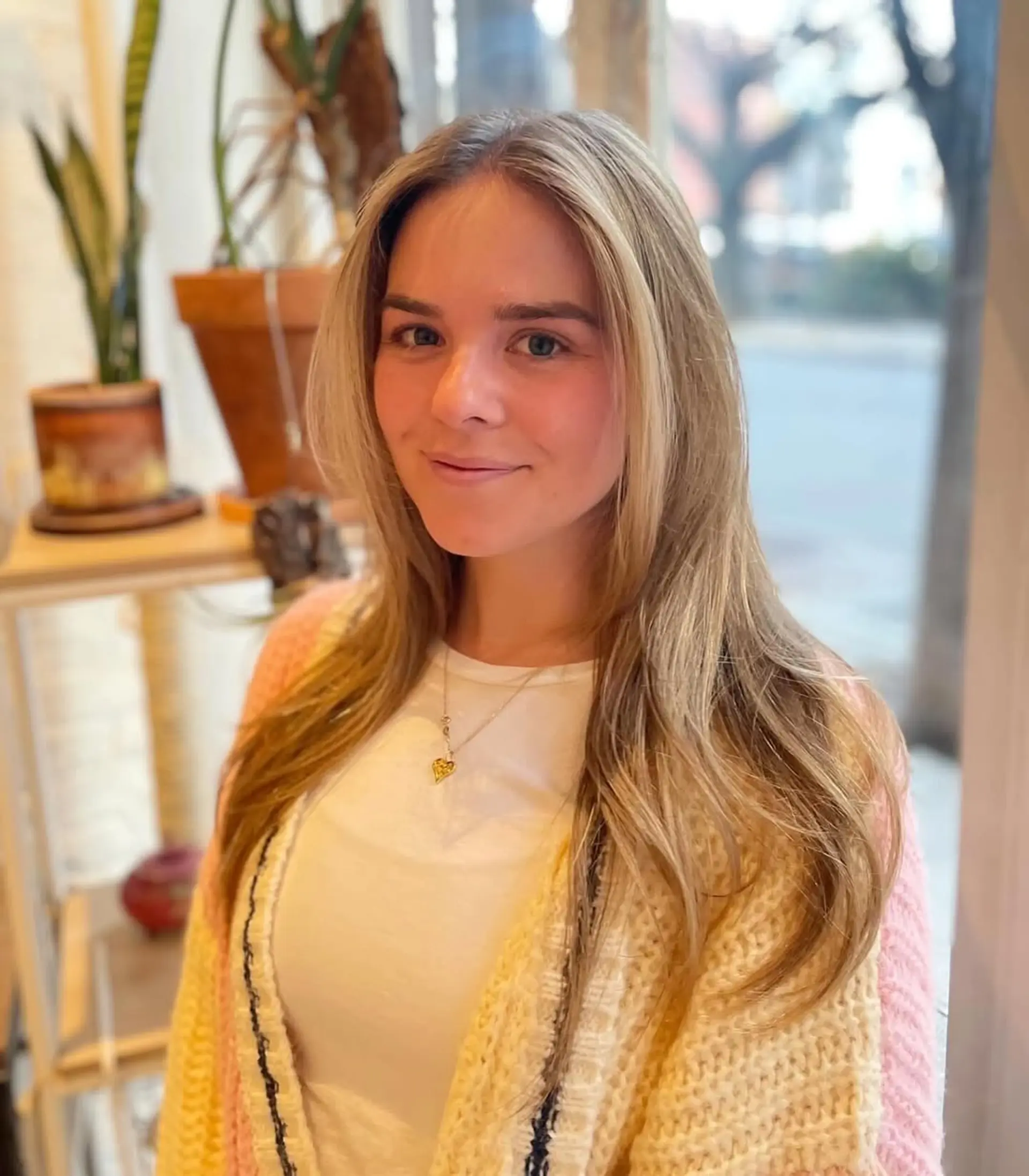 Long layered haircut with subtle face-framing layers and soft waves for a beachy look. 1