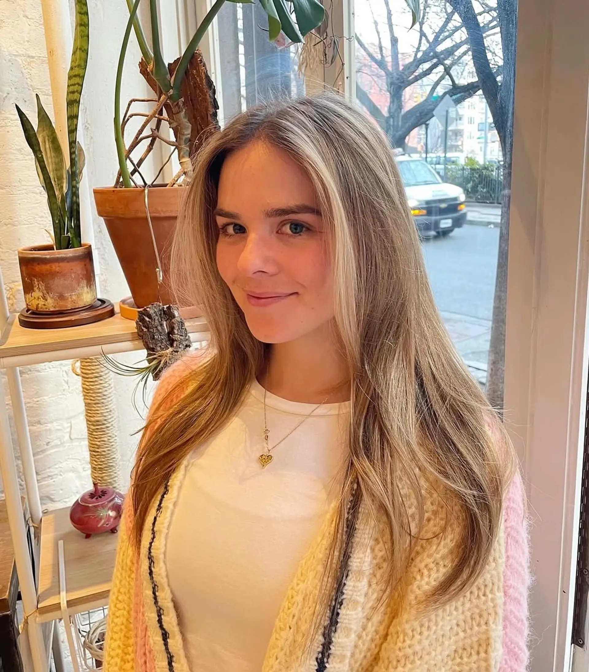 Long layered haircut with subtle face-framing layers and soft waves for a beachy look. 2