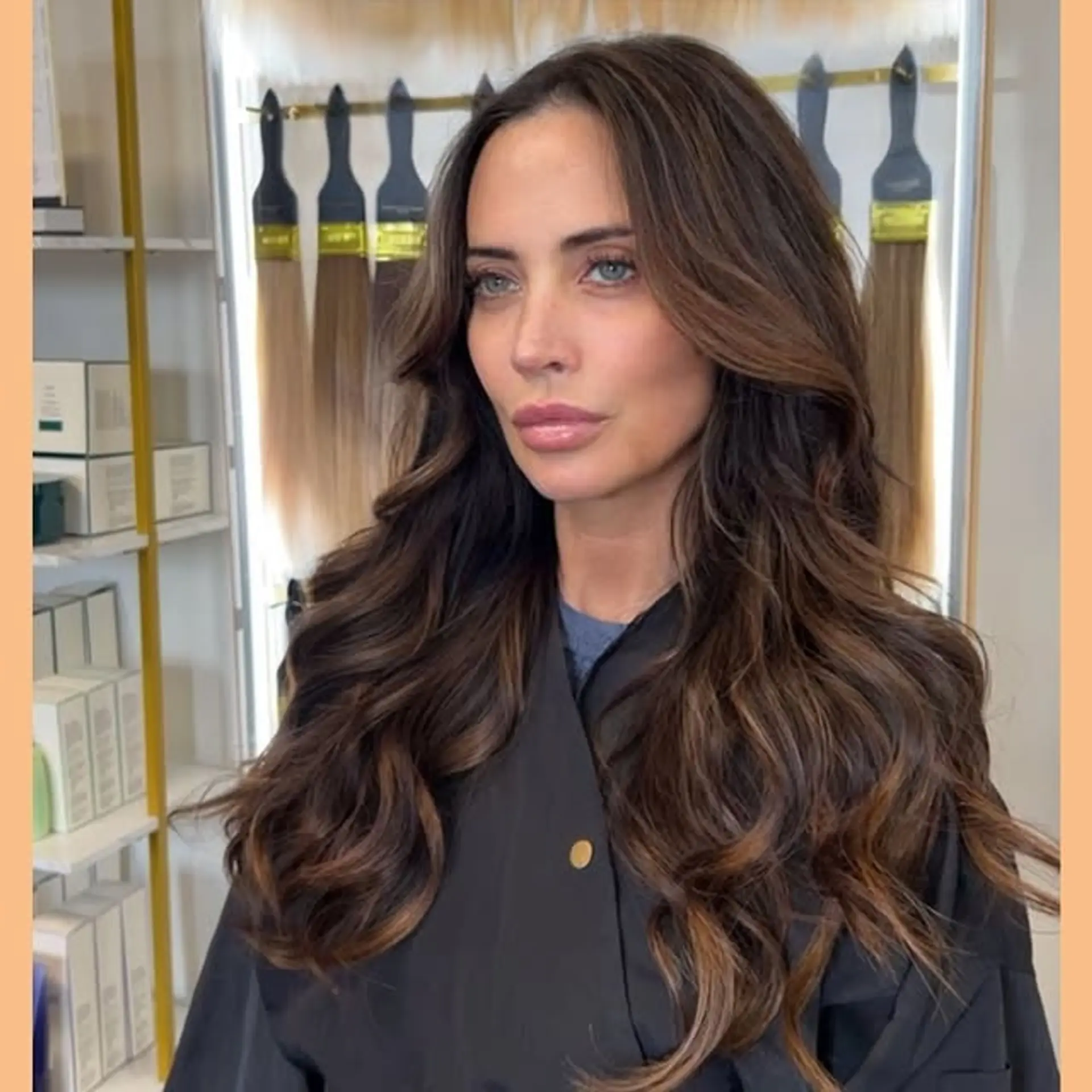 Long, layered hairstyle with soft waves and face-framing layers. 1