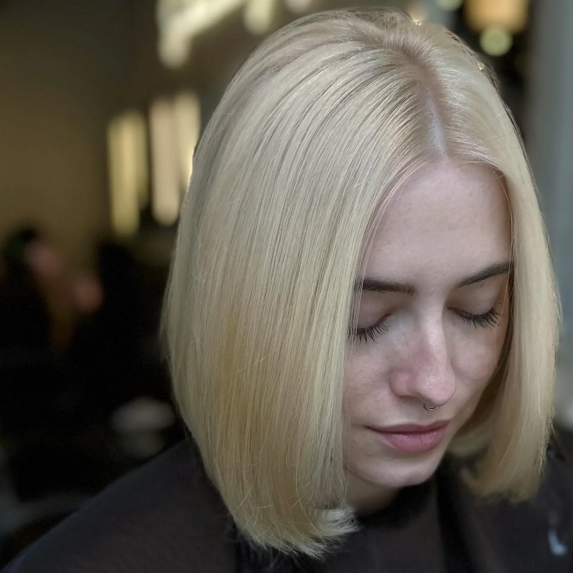 A sleek, modern blunt bob cut at shoulder length. 1