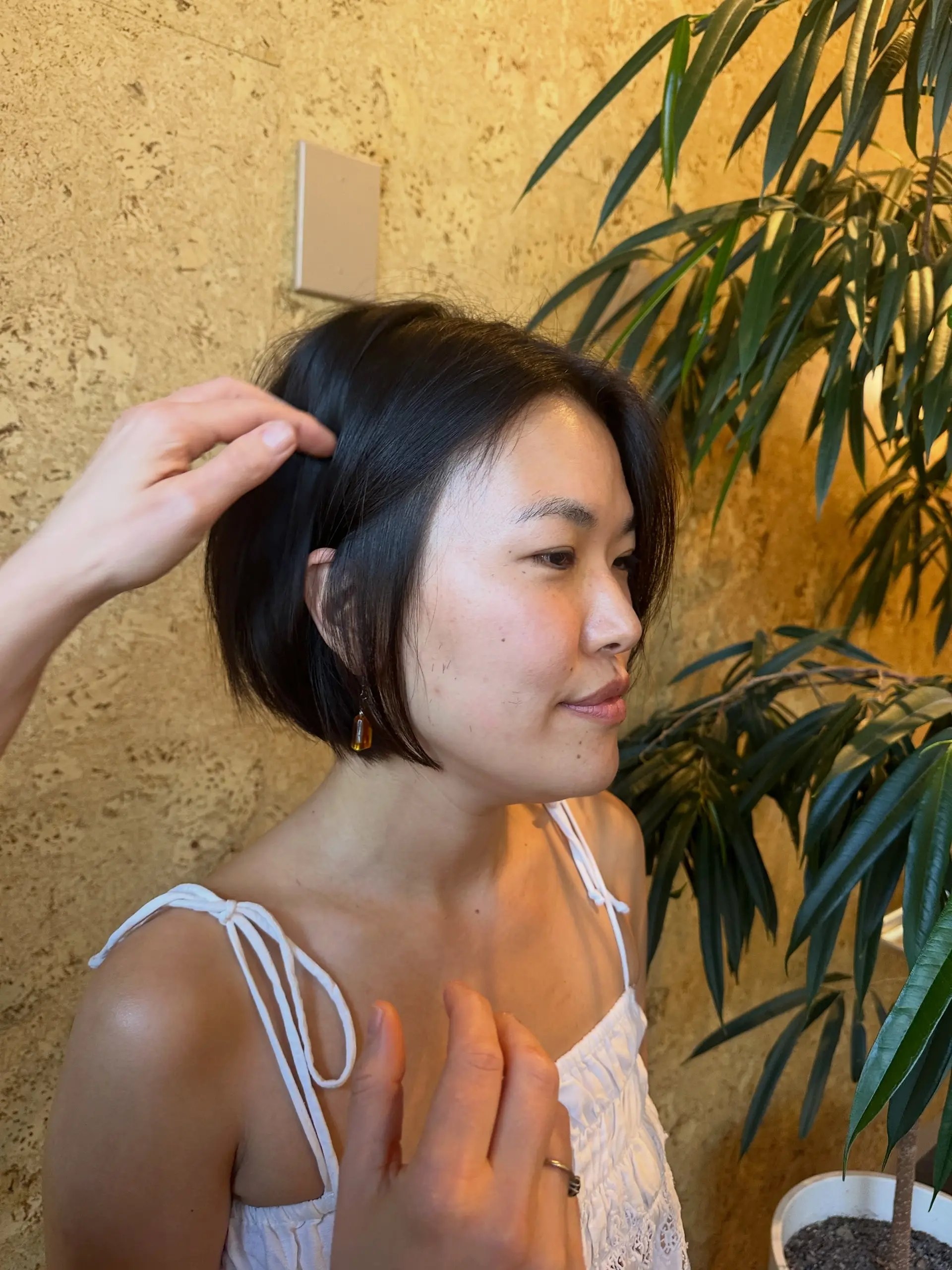 A sleek, chin-length dark bob cut with smooth straight texture framing the face. 1