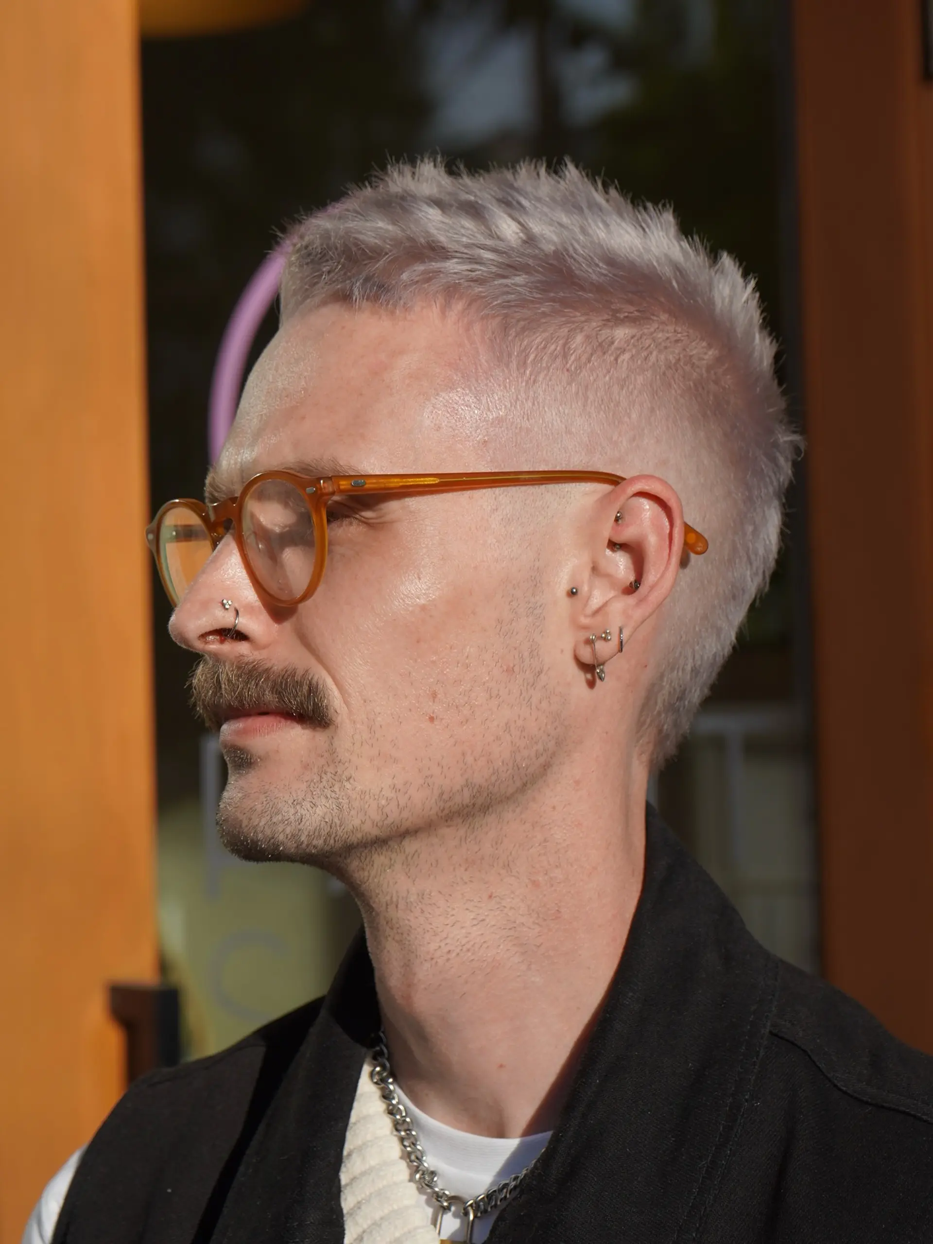A textured platinum silver short crop haircut featuring faded, closely cropped sides and a textured, piecey top. 1