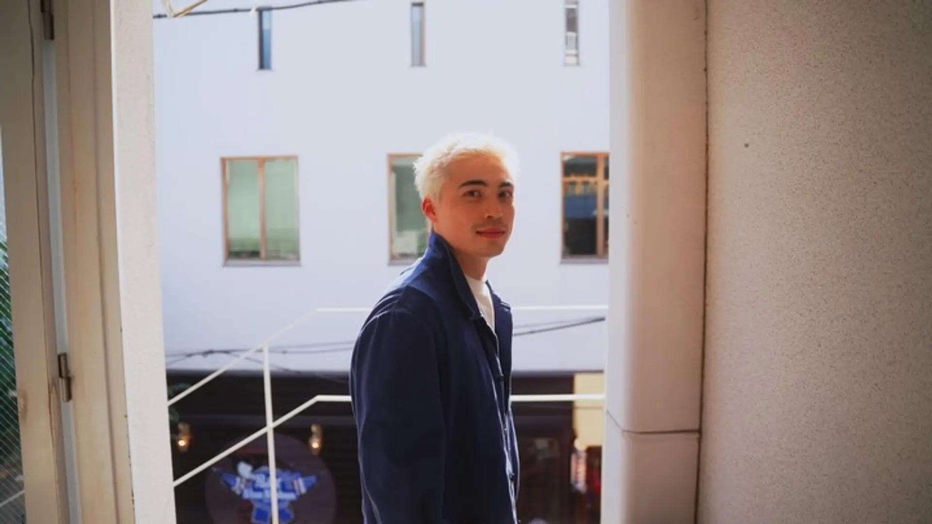 A short men's textured crop cut dyed in a bright platinum blonde shade and styled with soft spikes. 1