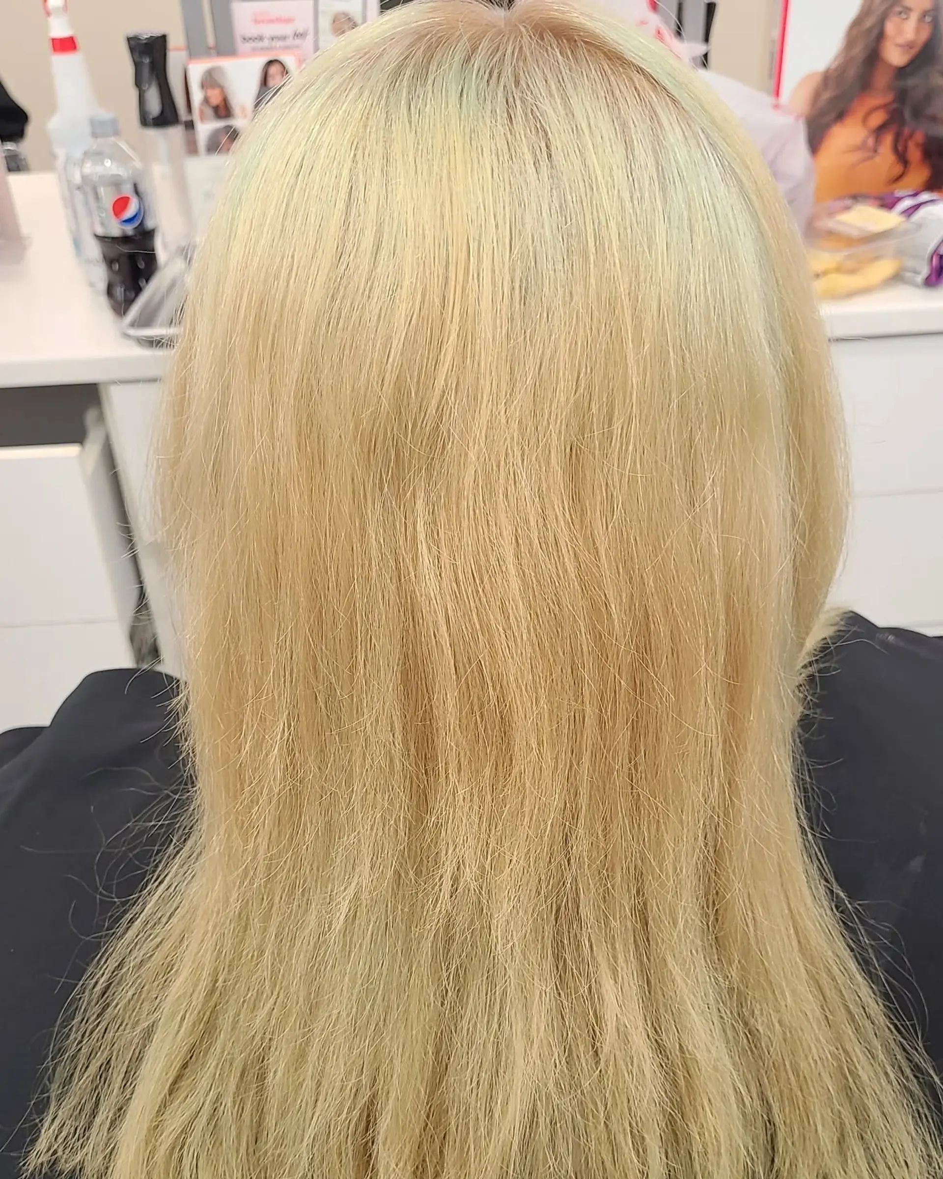 Long, wavy hair dyed in a striking rainbow palette of blues, pinks, purples, oranges, yellows, and greens, styled in a half-up twist secured with a decorative clip. 5