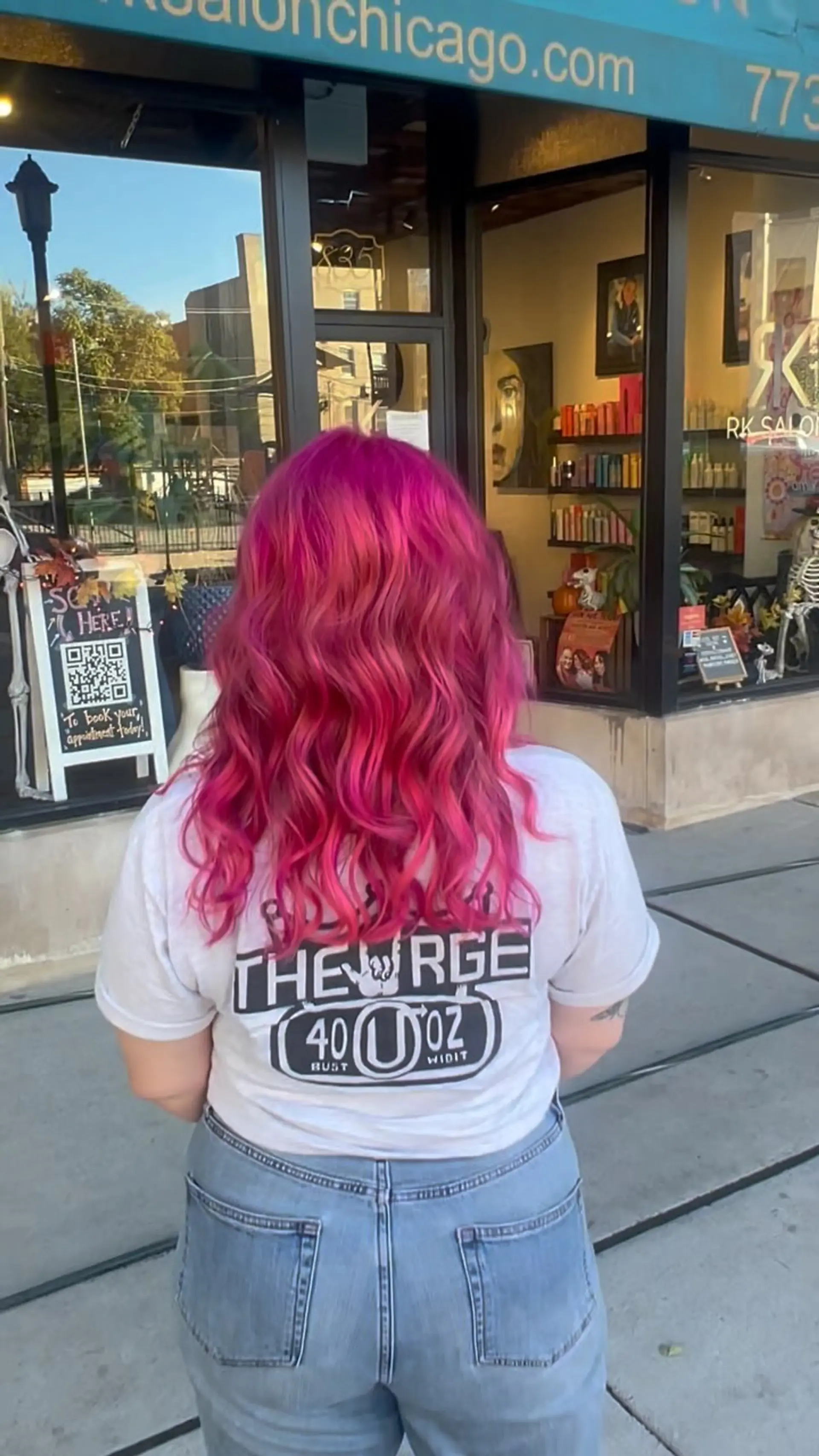 Vibrant magenta and hot pink hair styled in effortless, flowing waves. 1