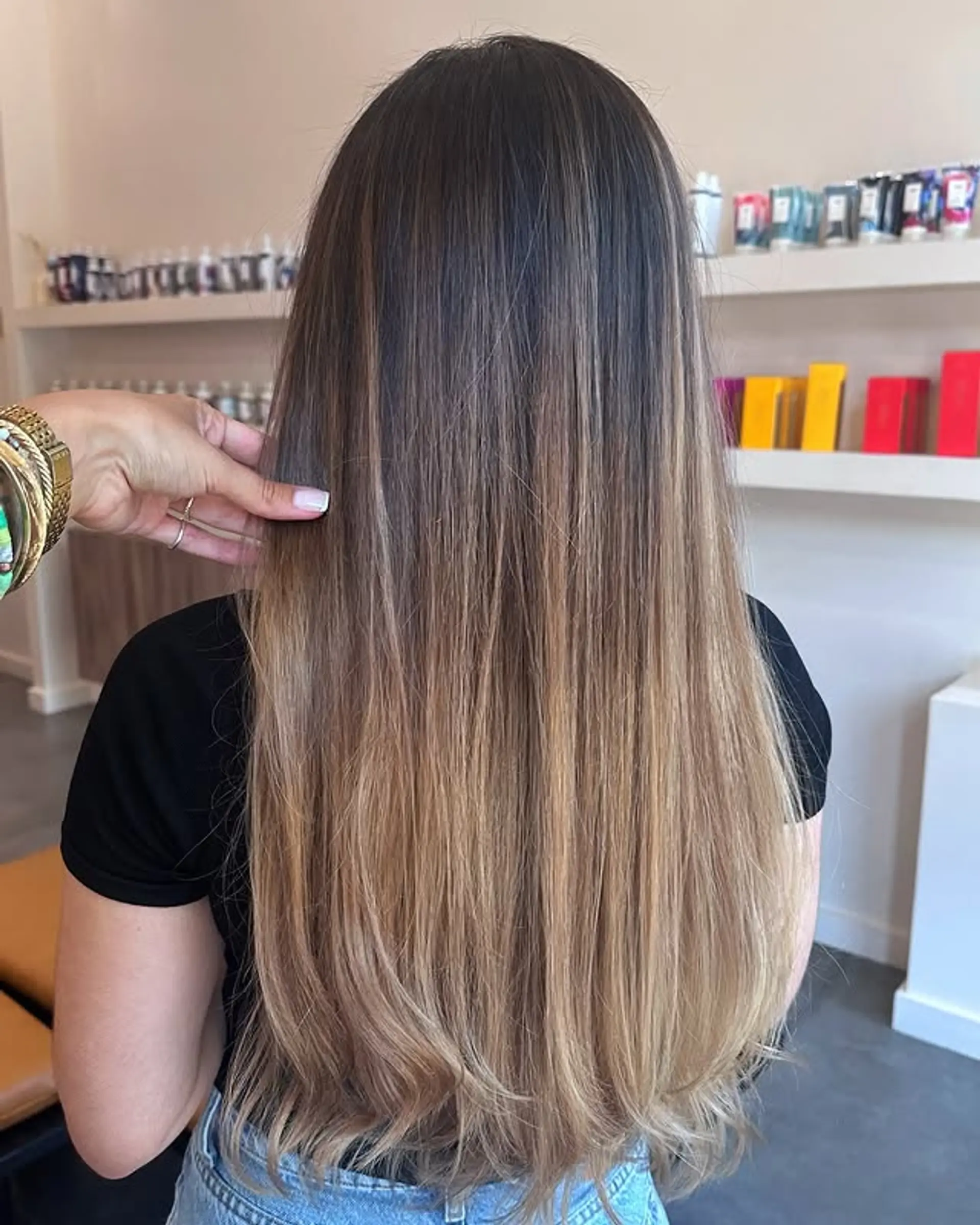 A long, straight hairstyle with a brunette to blonde ombre balayage. 1