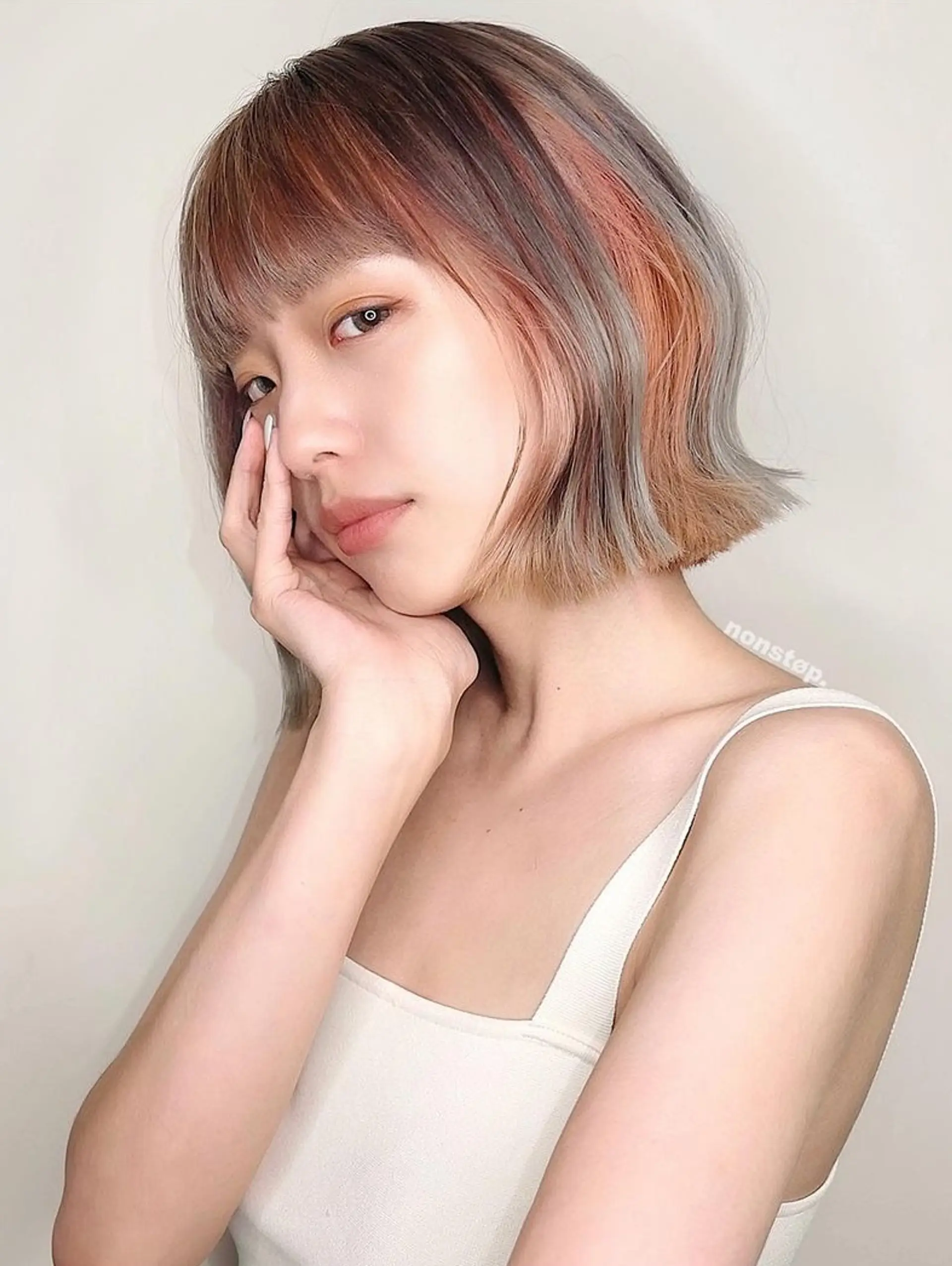 A stylish short bob featuring straight textures with straight bangs, two-toned copper and grey hues blending into black roots, and subtly angled ends framing the face. 🌄 Sunset girl by HIRO 1