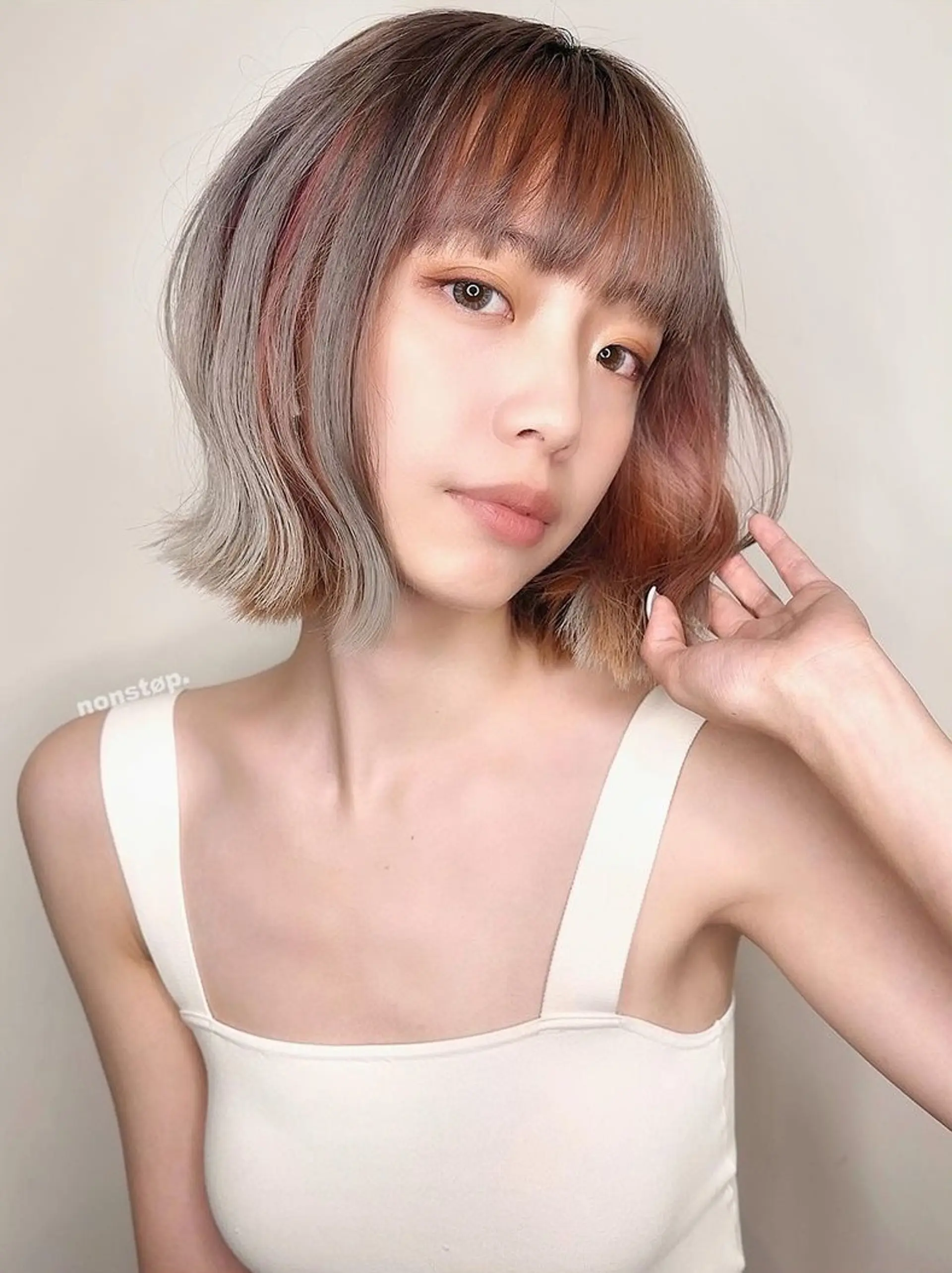 A stylish short bob featuring straight textures with straight bangs, two-toned copper and grey hues blending into black roots, and subtly angled ends framing the face. 🌄 Sunset girl by HIRO 3