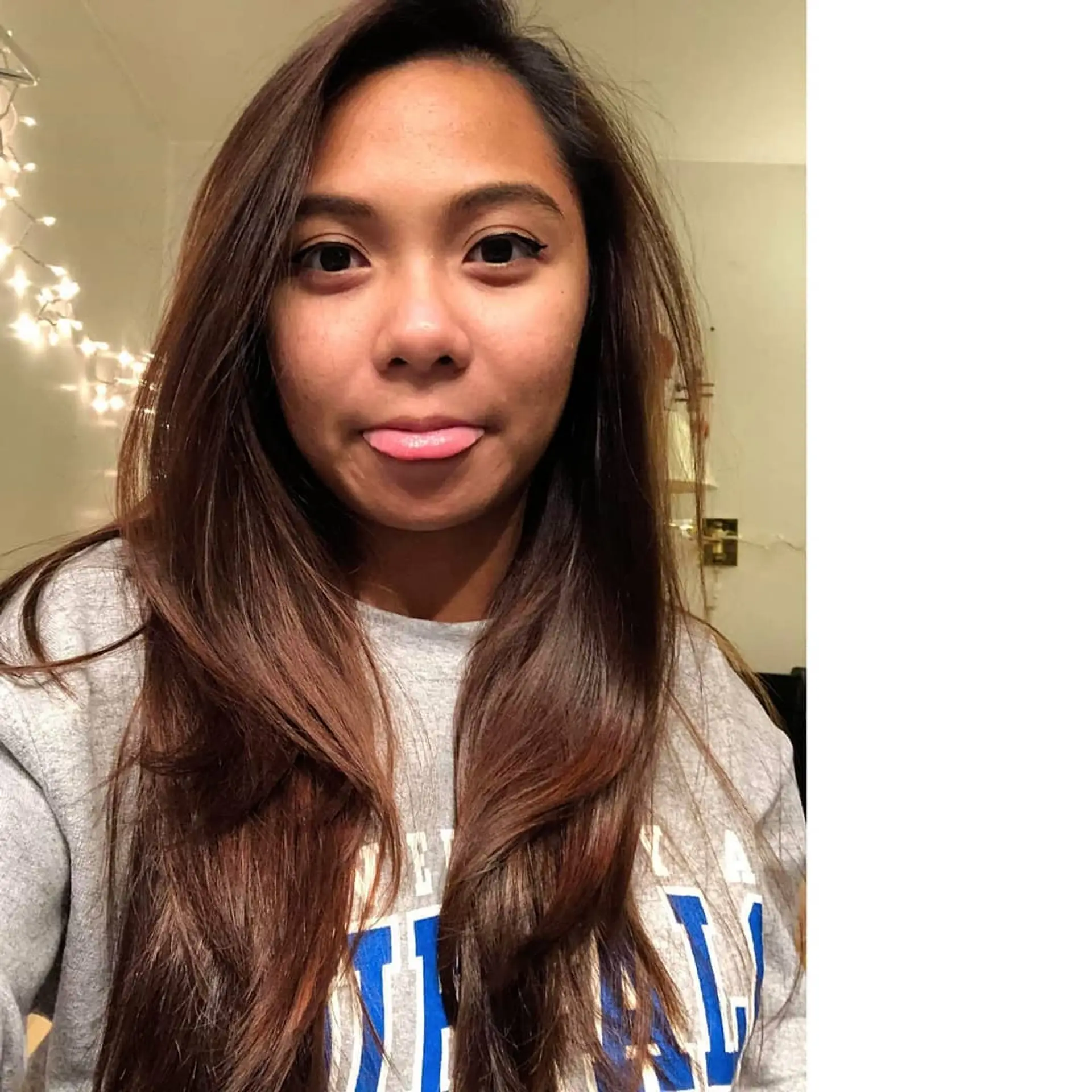 Long warm brunette hair styled with smooth face-framing layers and soft natural movement. 1