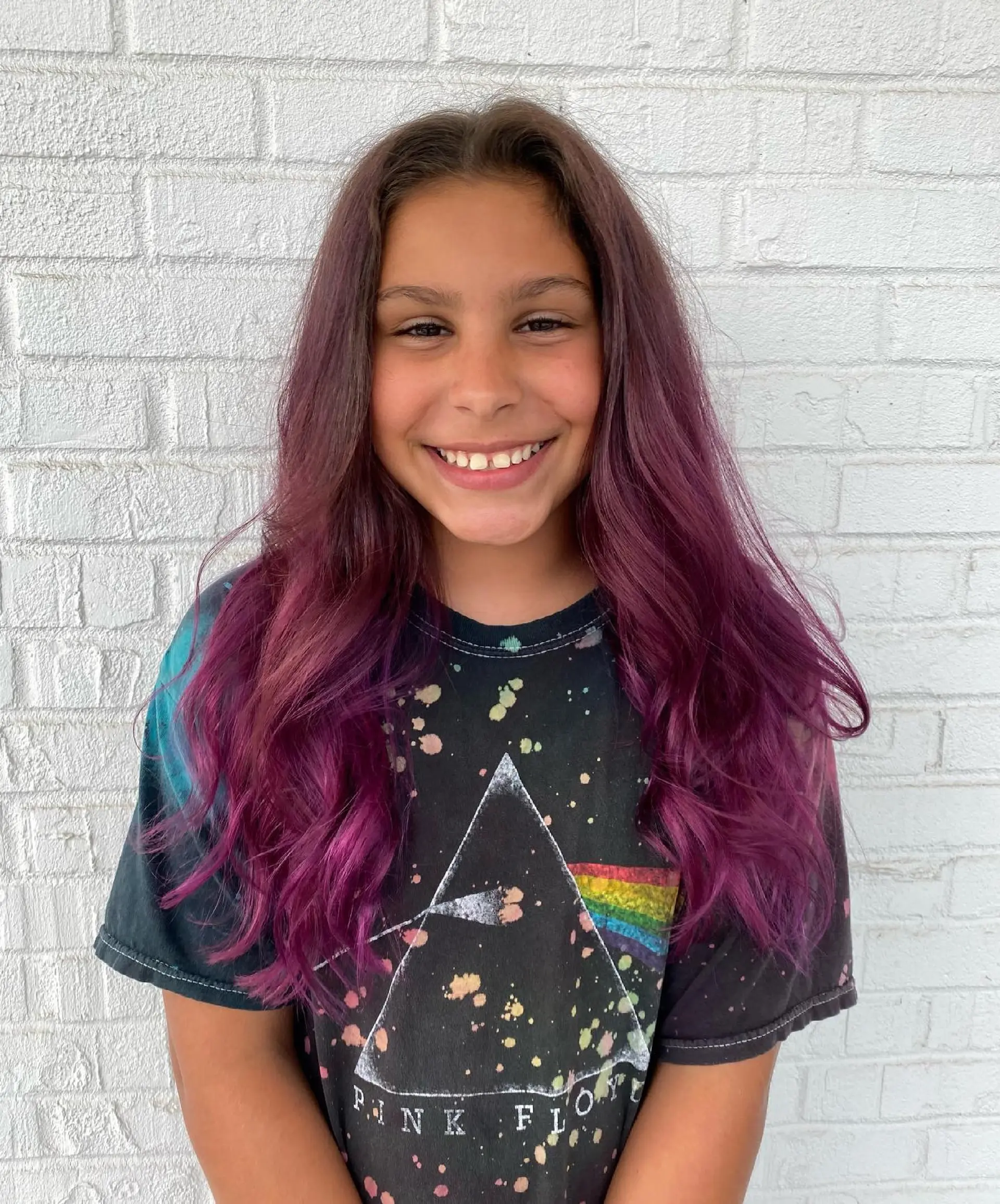 Long hair featuring a seamless balayage transitioning into rich purple and magenta tones, styled in soft waves. 1