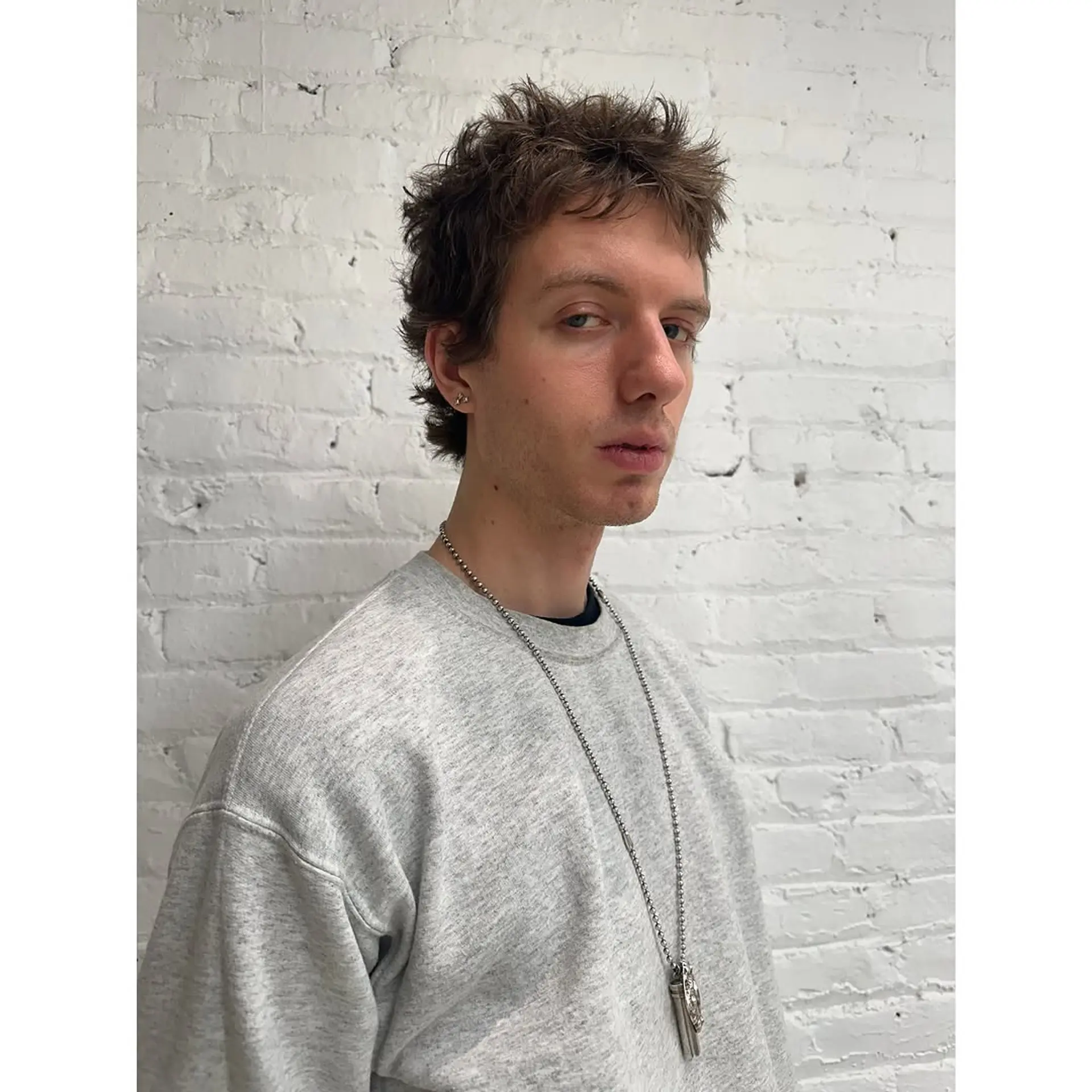 A short, wavy hairstyle with a messy, textured finish. 1