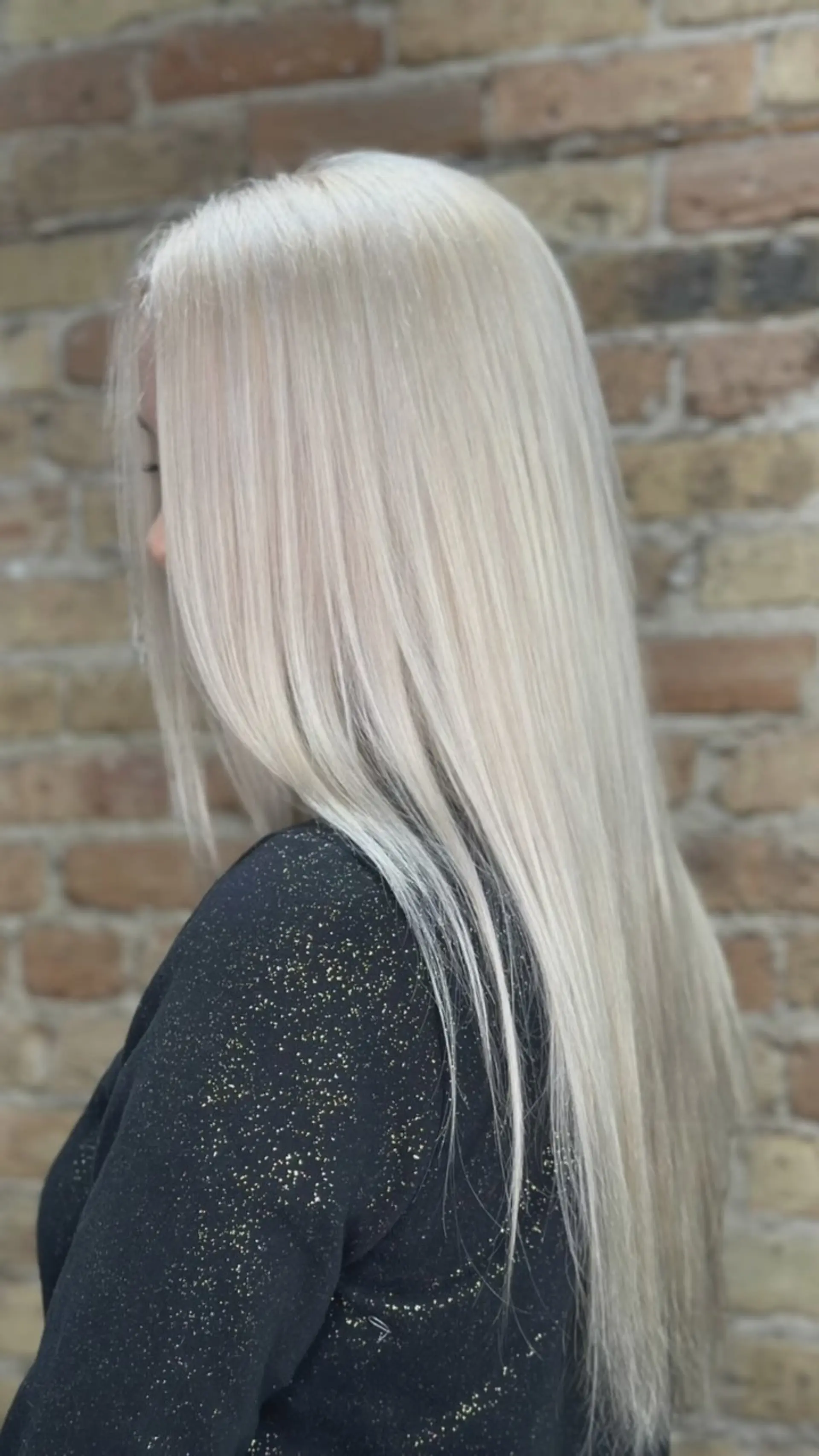 Long, pin-straight hair styled smoothly in an all-over icy platinum blonde shade. 1