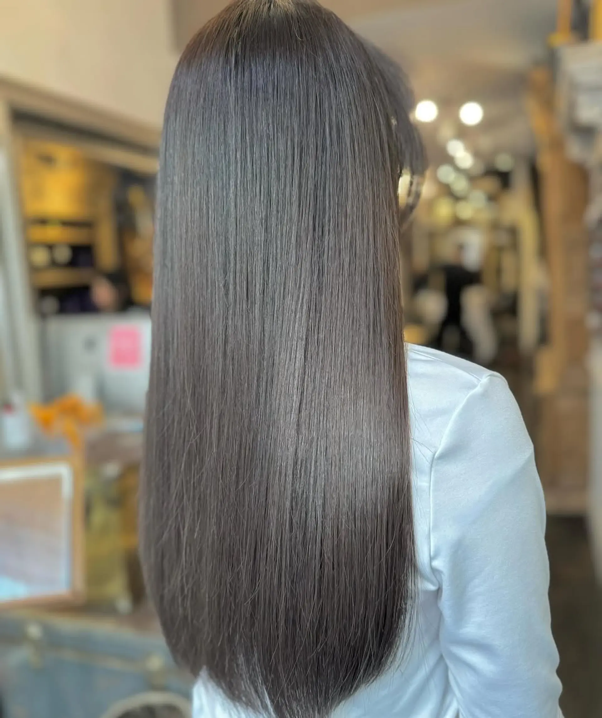 This style showcases very long, straight, and dark brown hair with sleek, glossy, and perfectly even strands. 3