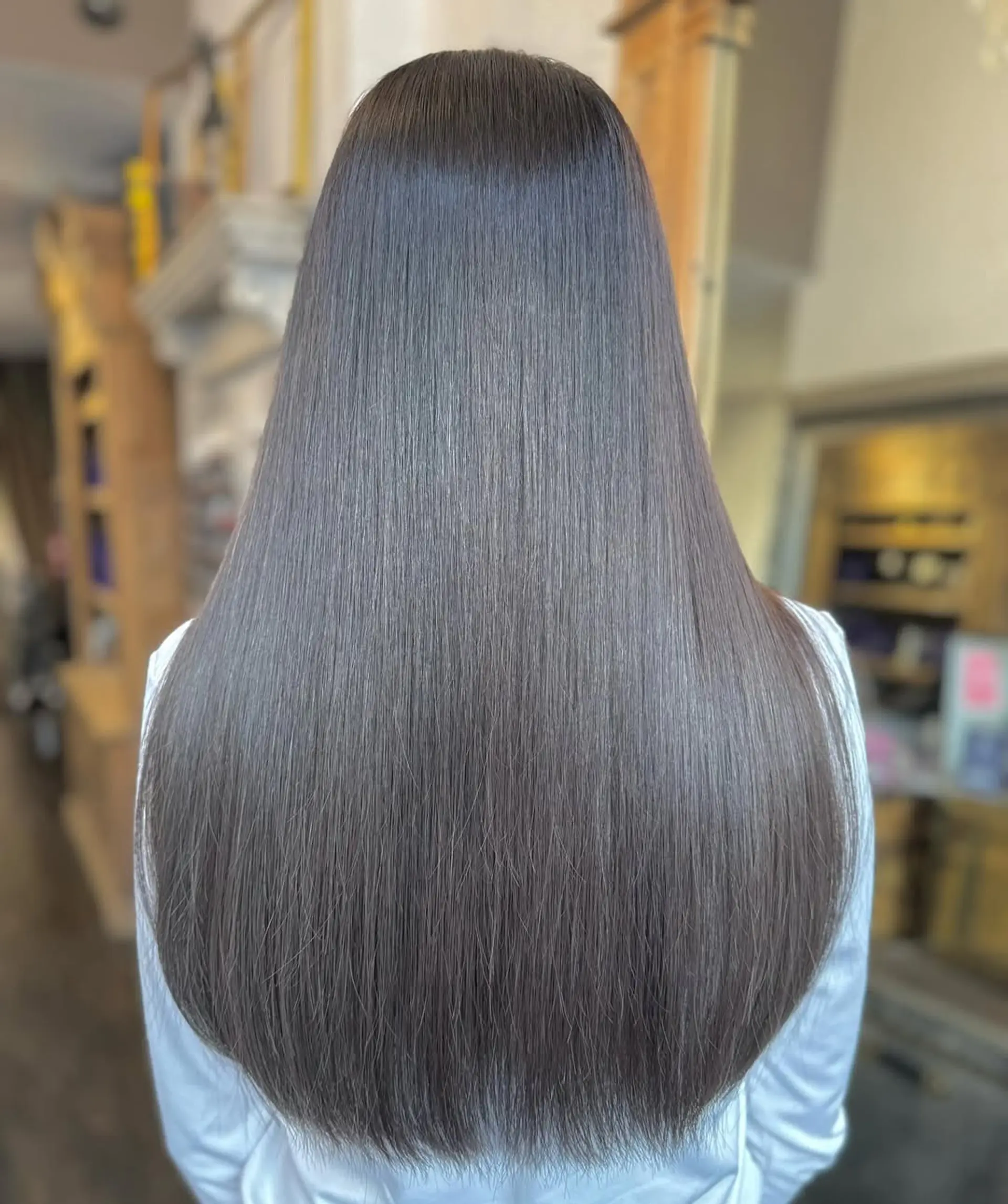 This style showcases very long, straight, and dark brown hair with sleek, glossy, and perfectly even strands. 1