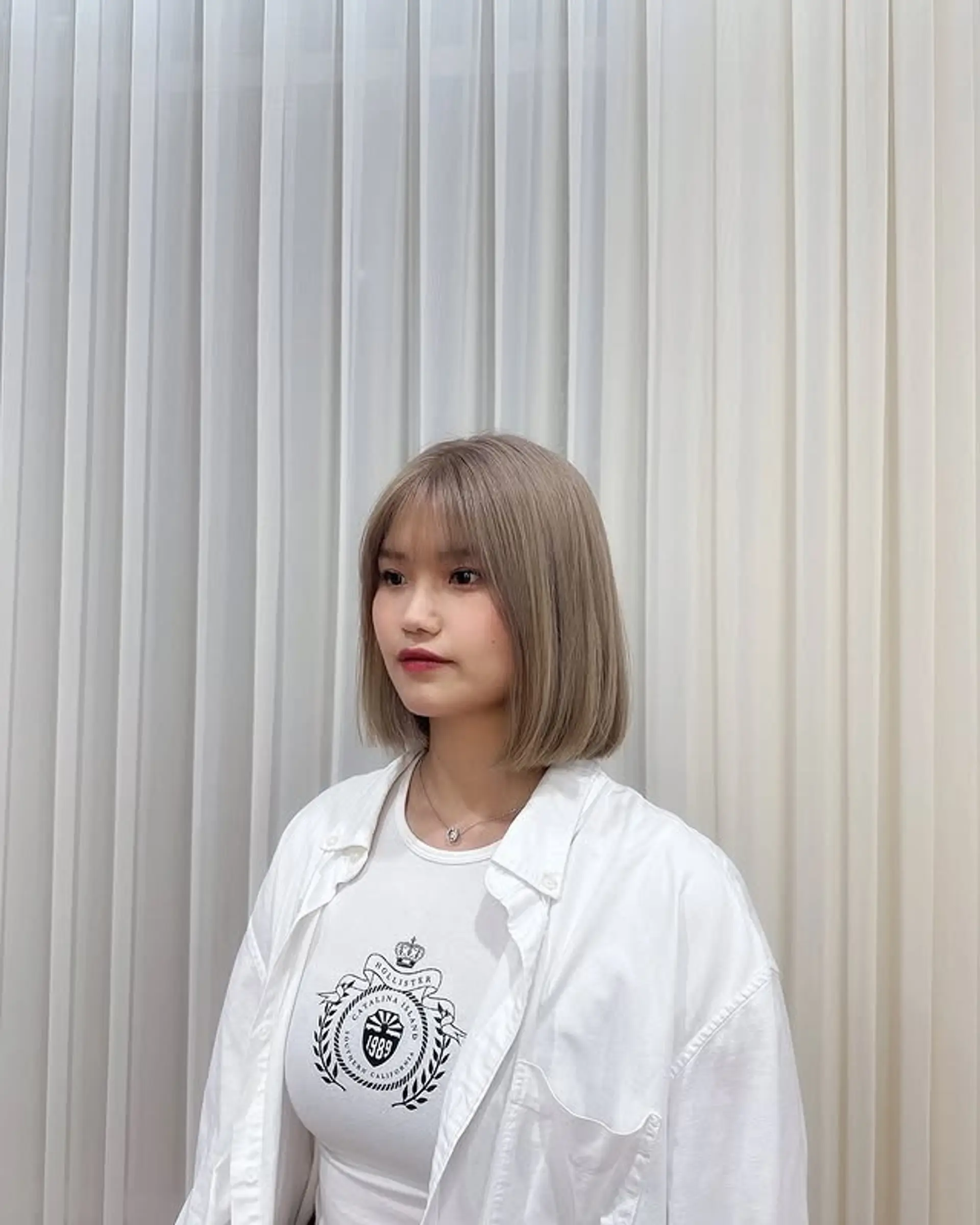 A chic blunt bob haircut featuring a straight across full fringe. 1