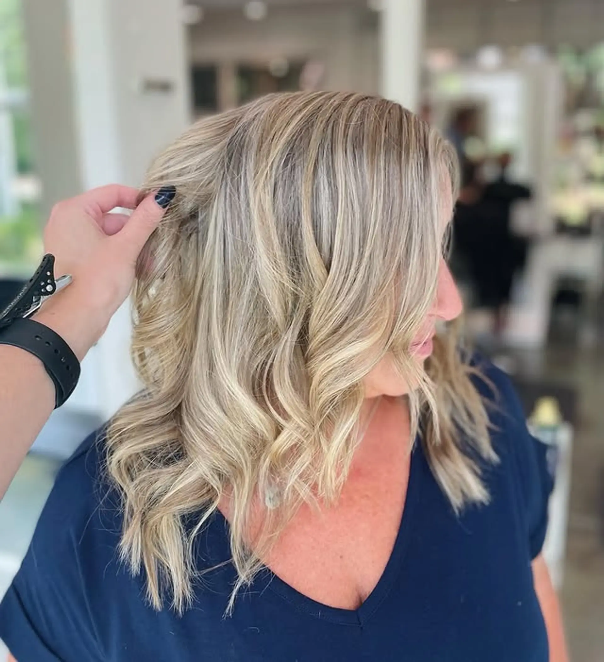 Medium wavy hair with a bronde balayage, creating a dimensional and sun-kissed effect. 1