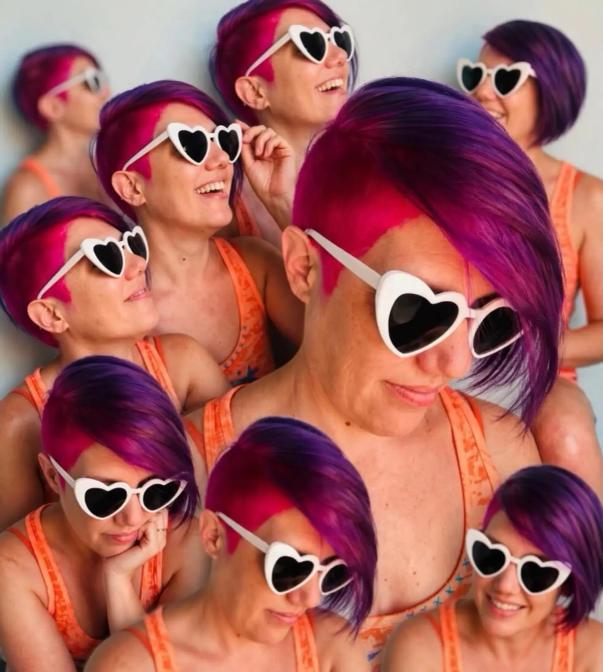 An edgy asymmetrical short haircut with closely cropped sides and longer side-swept bangs in bright magenta and deep purple tones. 1