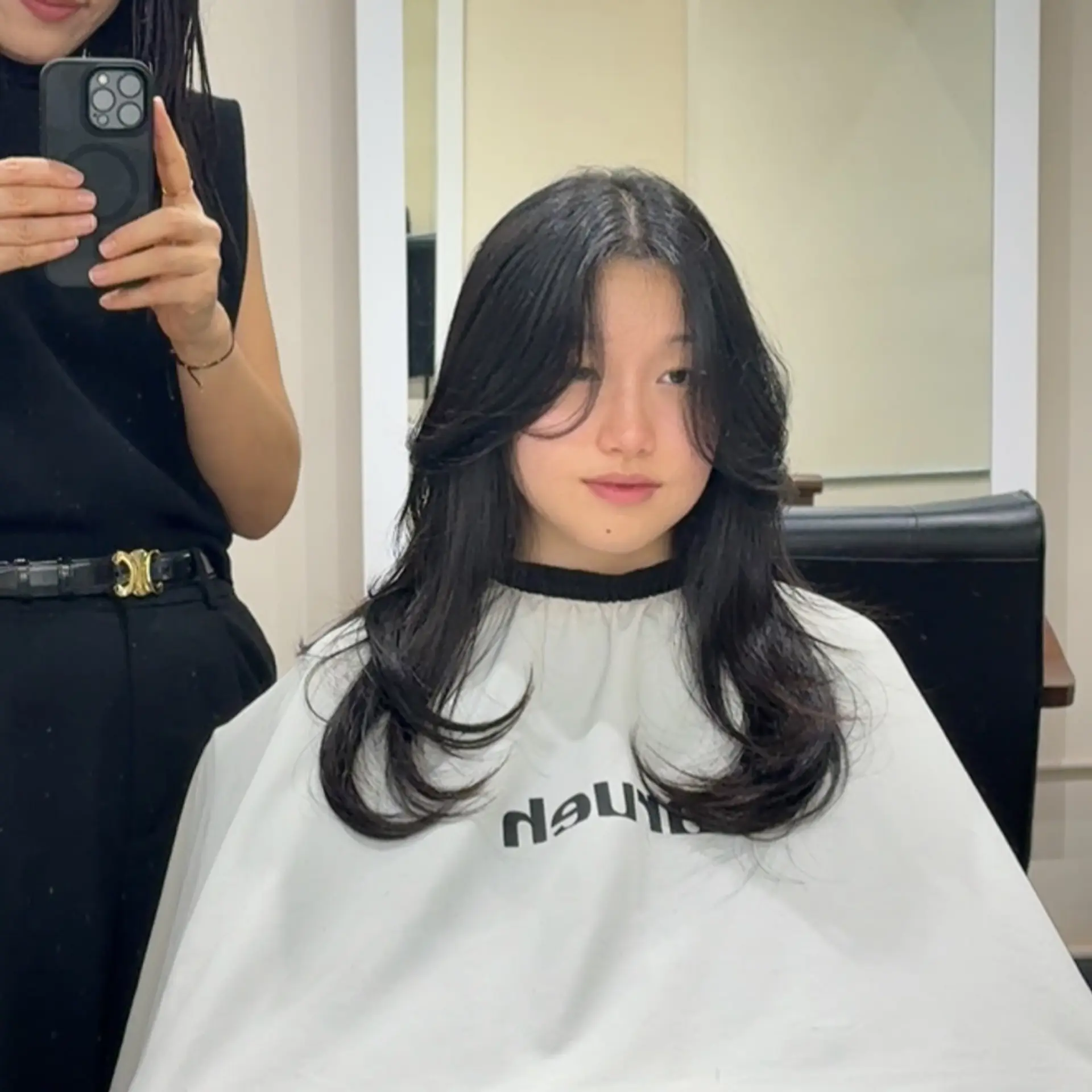 A layered butterfly cut that incorporates face-framing curtain bangs to add movement and volume, focusing on soft, cascading layers that curve inwards toward the face. 1