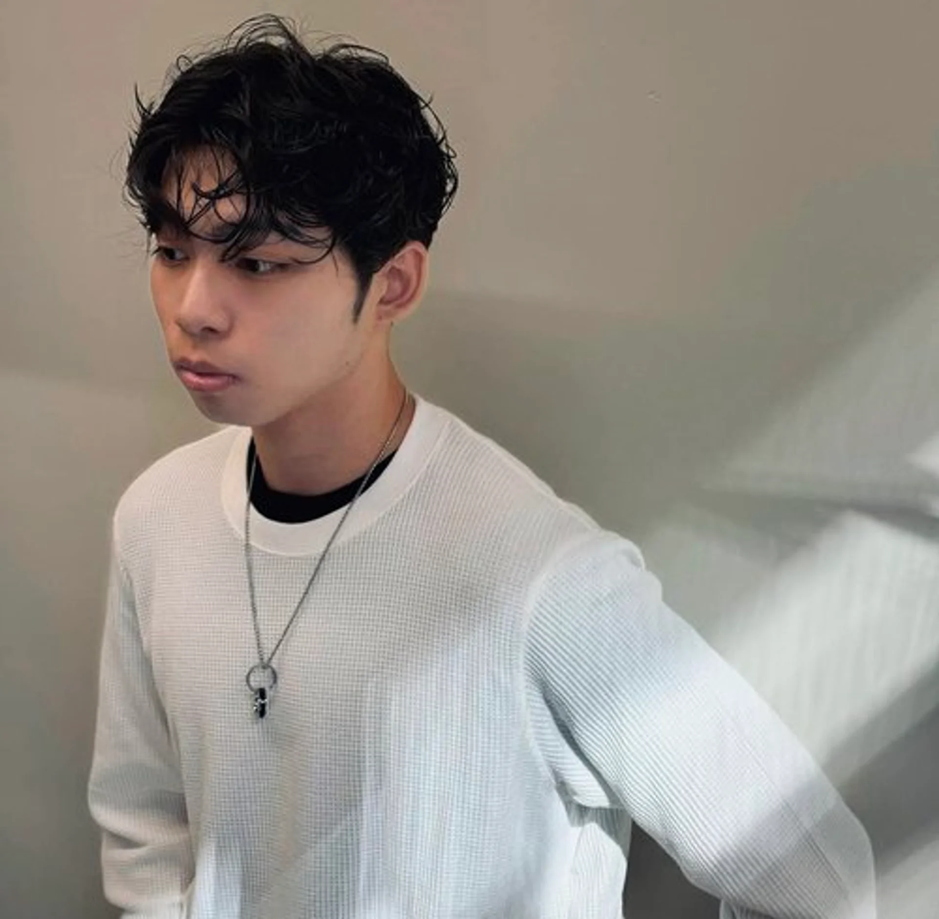 Man with a modern perm featuring effortlessly textured waves - Preview 2