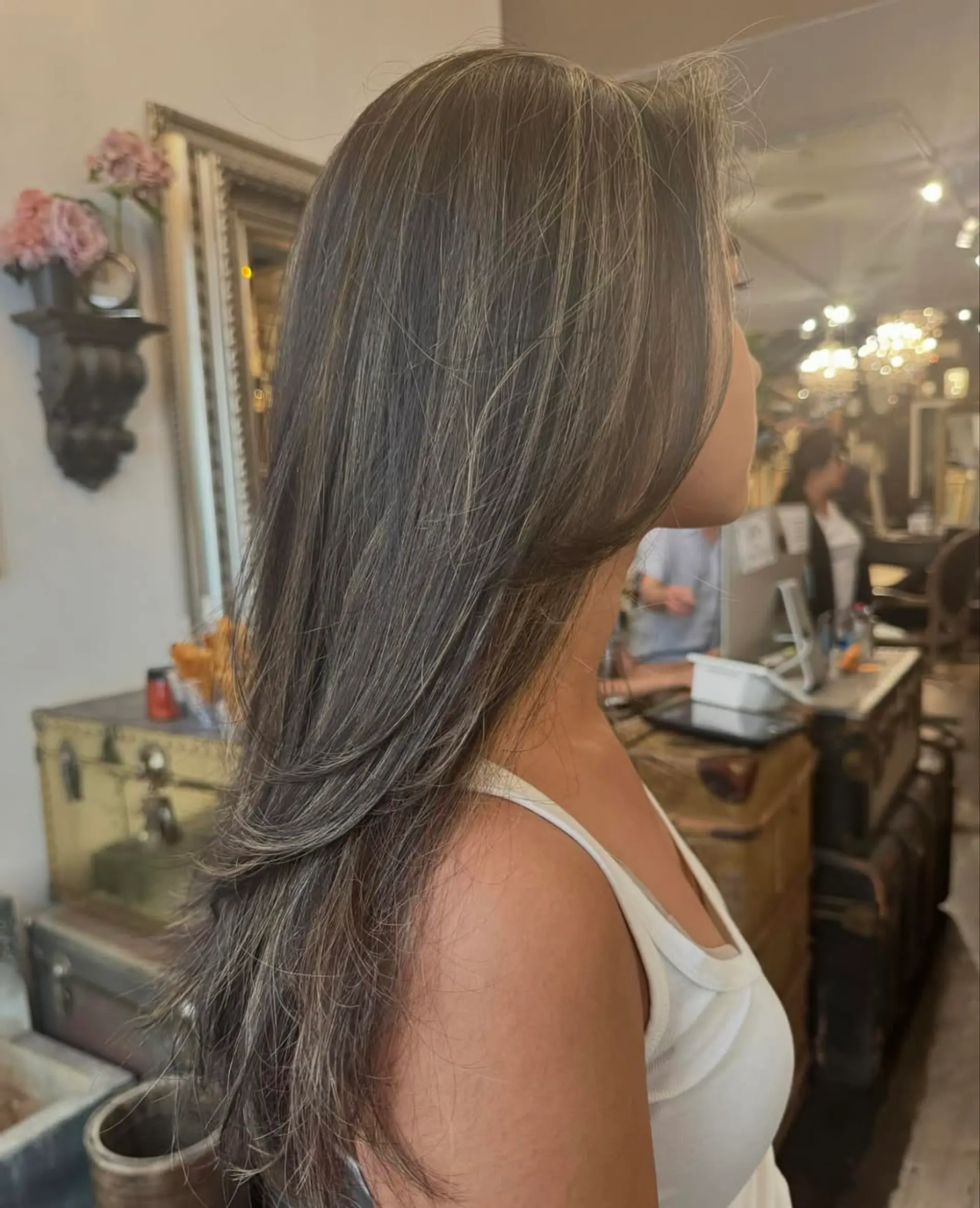 Long, straight, dark brown hair with ash blonde highlights, layered for volume with a sleek finish. 3