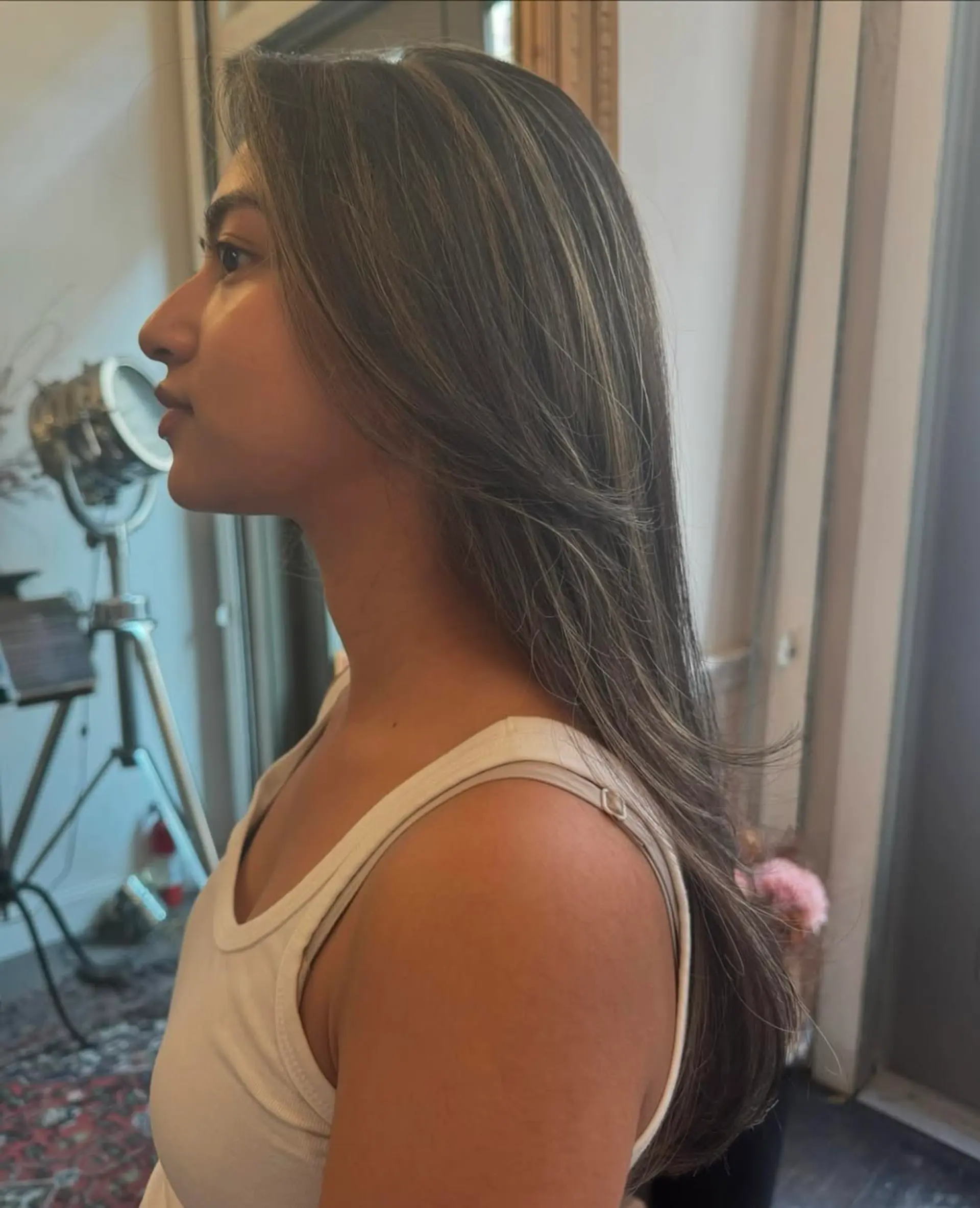 Long, straight, dark brown hair with ash blonde highlights, layered for volume with a sleek finish. 4
