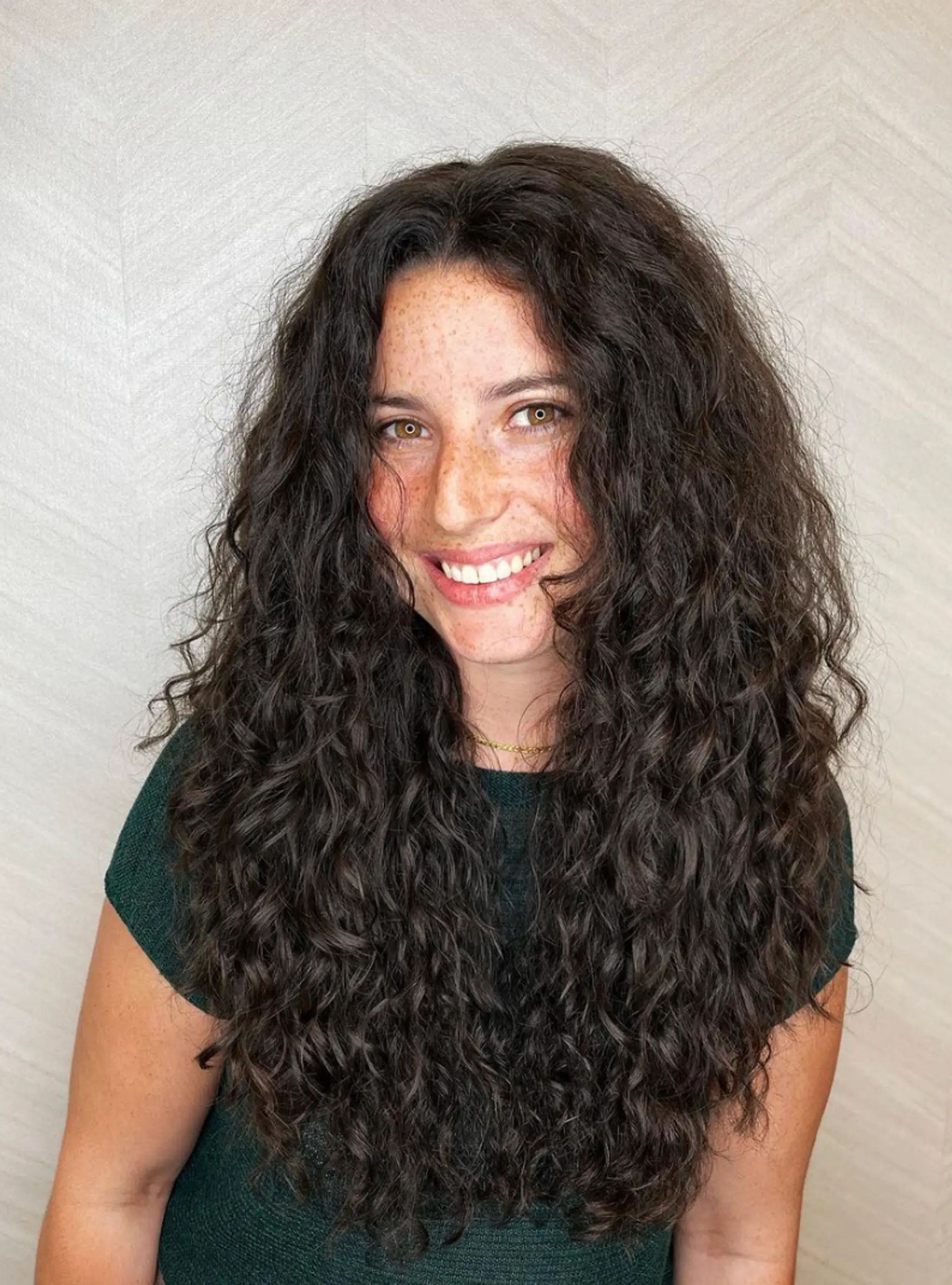 Long, dark brown, full-bodied curls with natural volume and layered texture.

Cut and style by @juliamannino_hair


