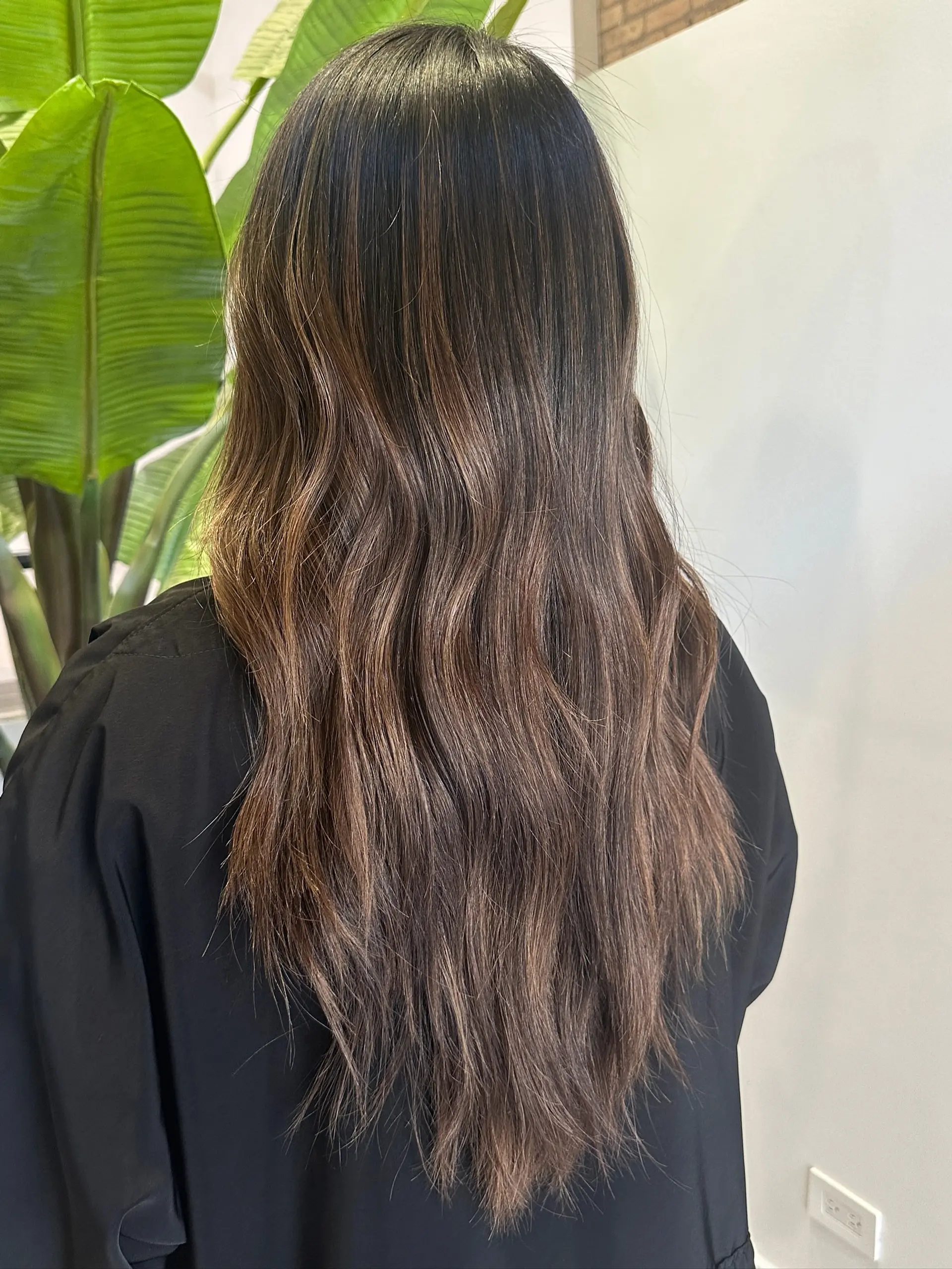 Long wavy hair with face-framing layers and a balayage color effect. 3