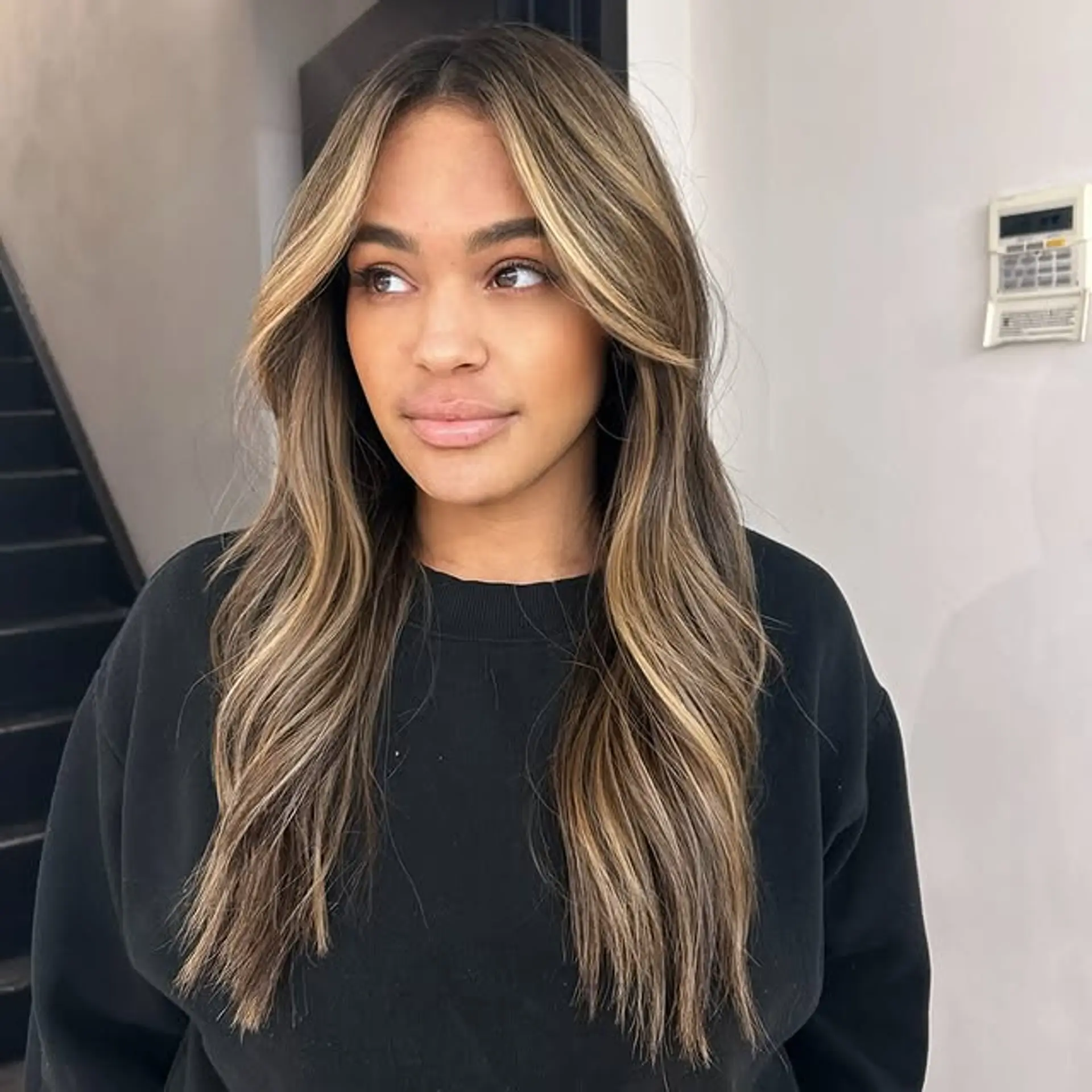 Long layered cut with face-framing highlights and soft waves. 1