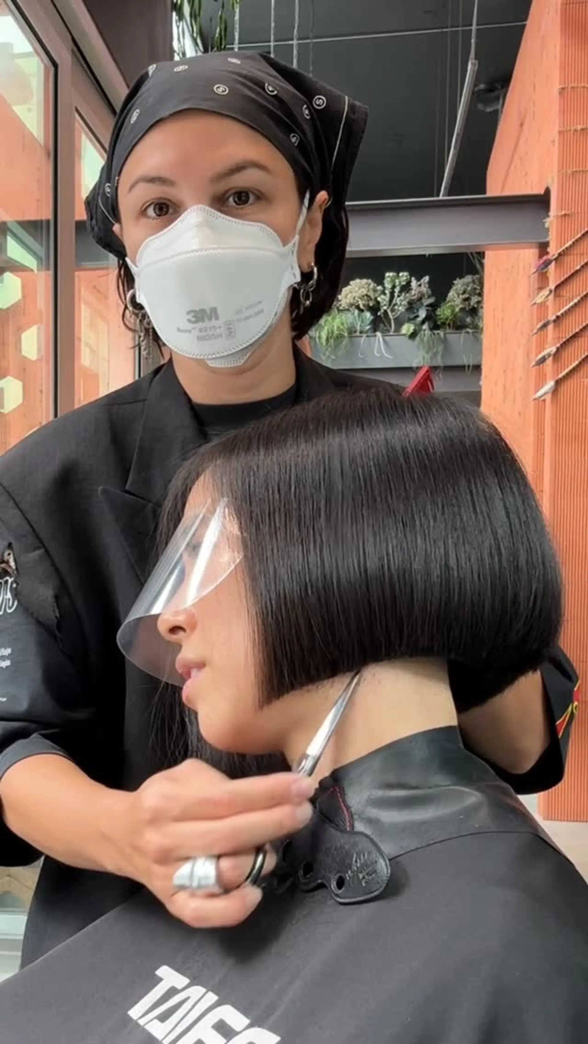 A sharp, chin-length blunt bob with a crisp horizontal perimeter and sleek straight finish. 1