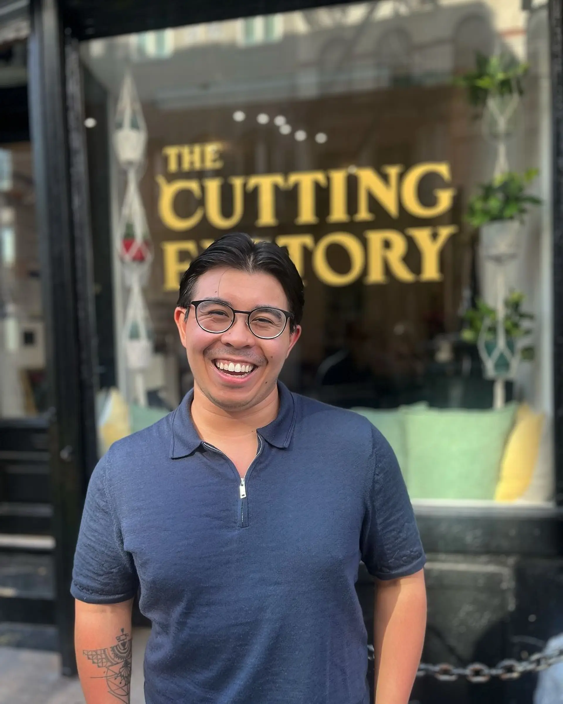 A Classic Taper hairstyle with short, straight, black hair; neatly trimmed with well-defined lines for a clean, polished appearance. 1