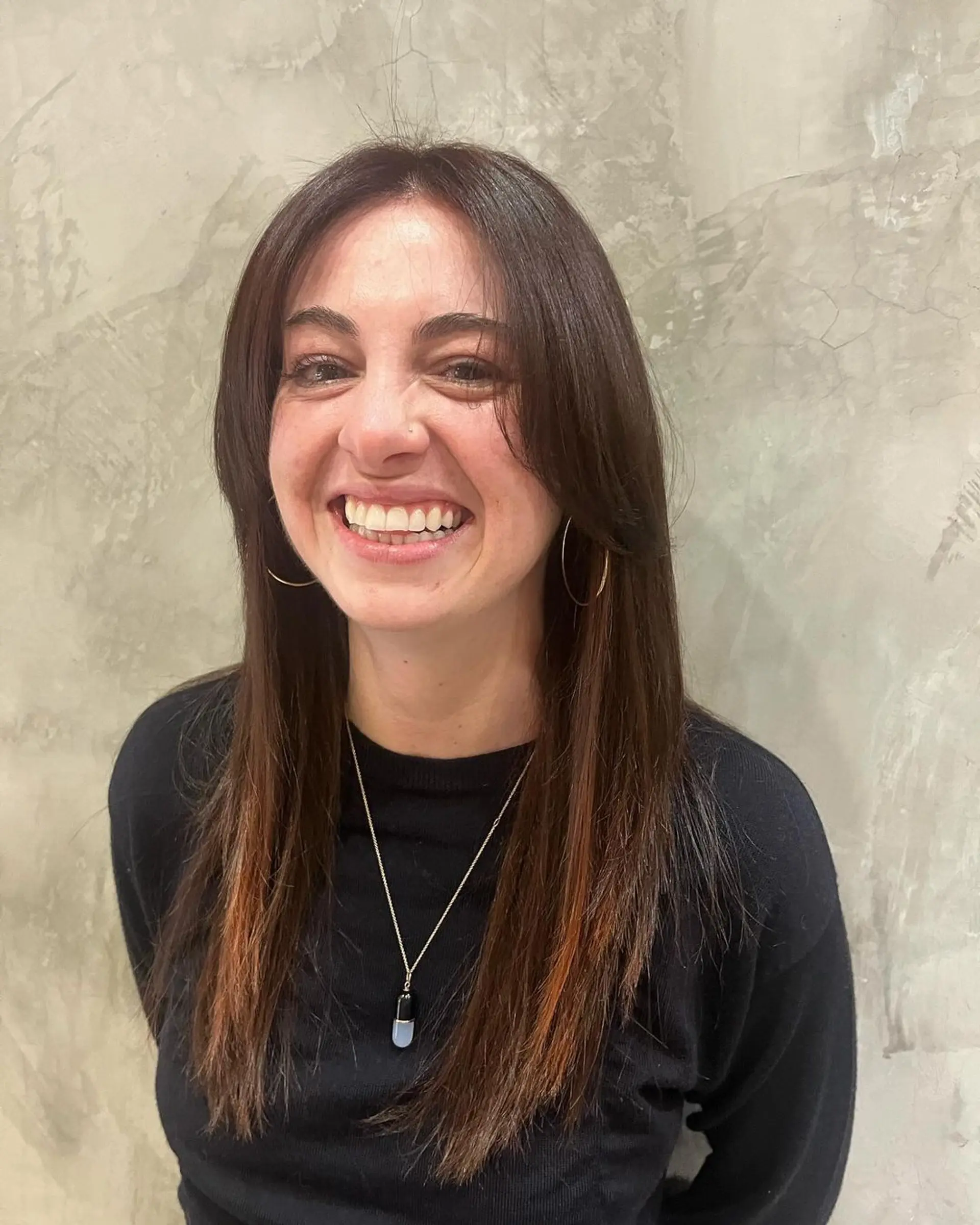 Medium-length, straight hair with a middle part, brown color, and subtle auburn highlights, finished with a smooth texture. 1